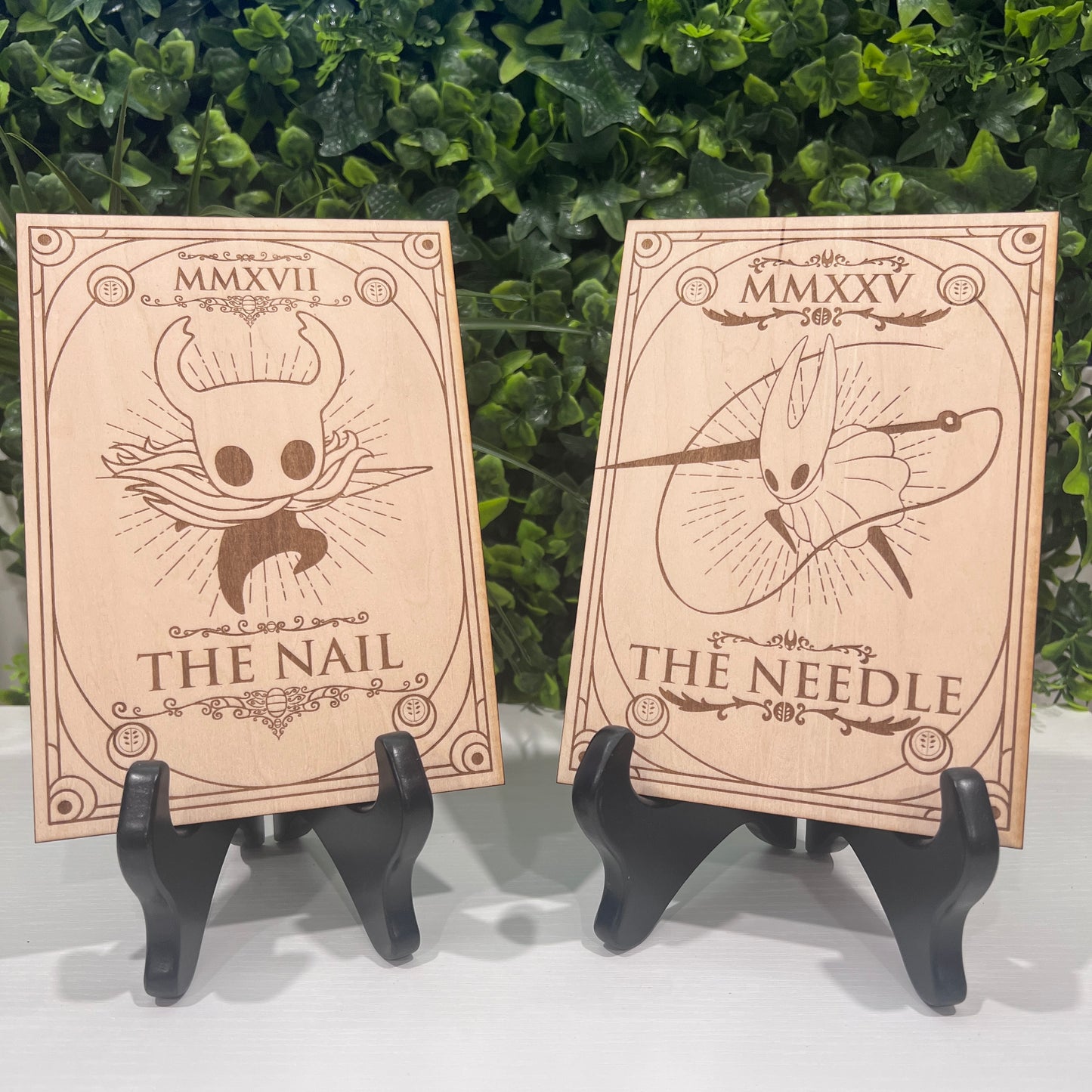 Set of two laser engraved wood tarot cards featuring Hollow Knight as The Nail and Hornet as the Needle. Unique indie game fan art collectible.