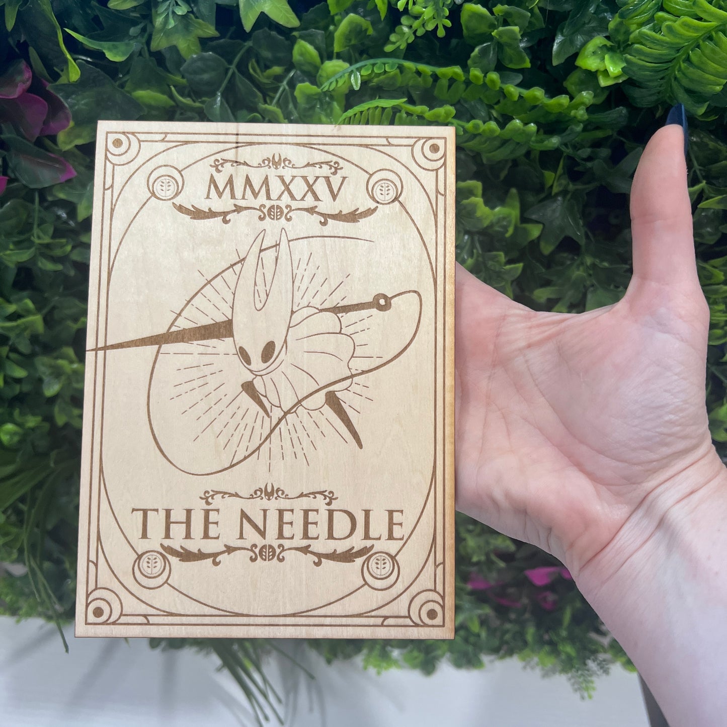 Set of two laser engraved wood tarot cards featuring Hollow Knight as The Nail and Hornet as the Needle. Unique indie game fan art collectible.