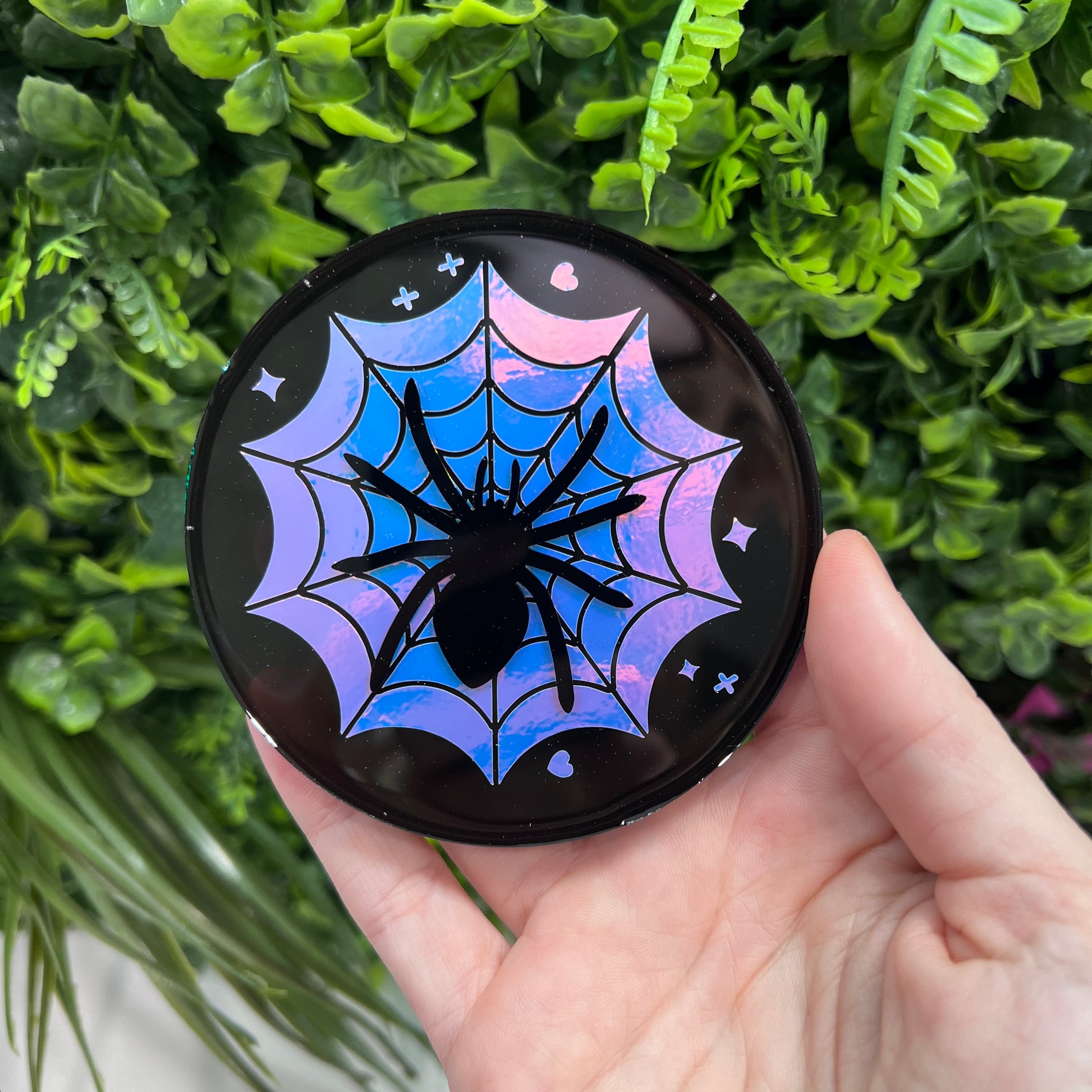 Pastel goth spiderweb coasters featuring a handmade resin design with intricate spiderwebs. Perfect for adding a dark, spooky aesthetic to any home. These unique coasters blend pastel colors with a goth twist, great for goth or Halloween-themed decor