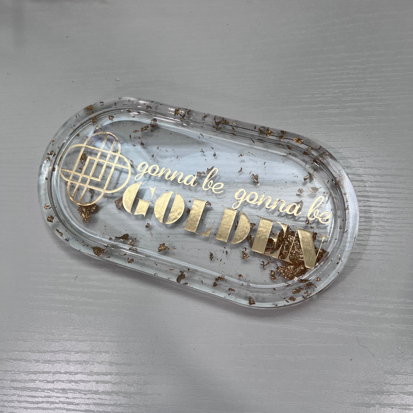 Handmade resin trinket tray with gold leaf and the quote “Gonna Be Gonna Be Golden.” Kpop Demon Hunters–inspired jewelry dish, perfect for gifts or décor.