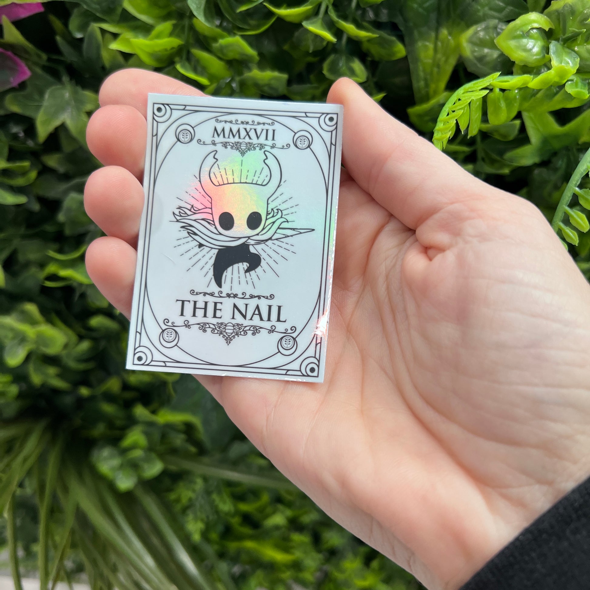Silver Holographic tarot card stickers featuring Hollow Knight as The Nail and Hornet as the Needle. Unique indie game fan art collectible.