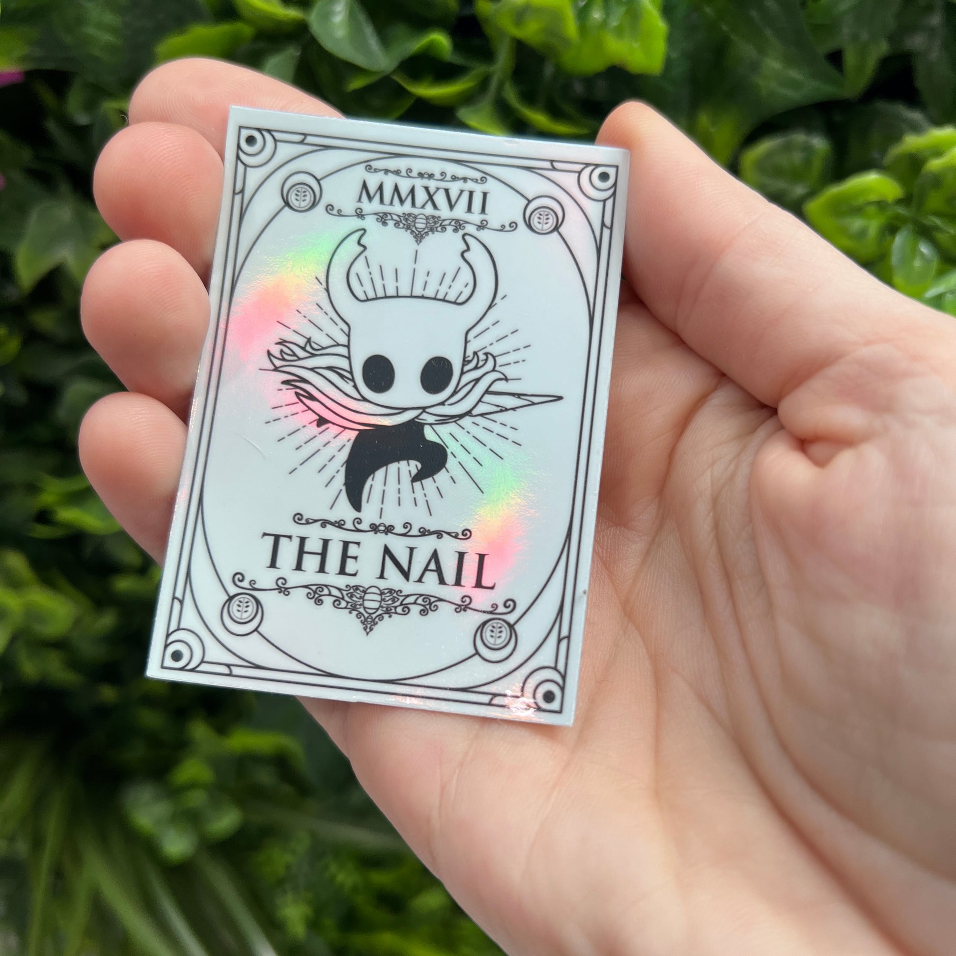 Silver Holographic tarot card stickers featuring Hollow Knight as The Nail and Hornet as the Needle. Unique indie game fan art collectible.