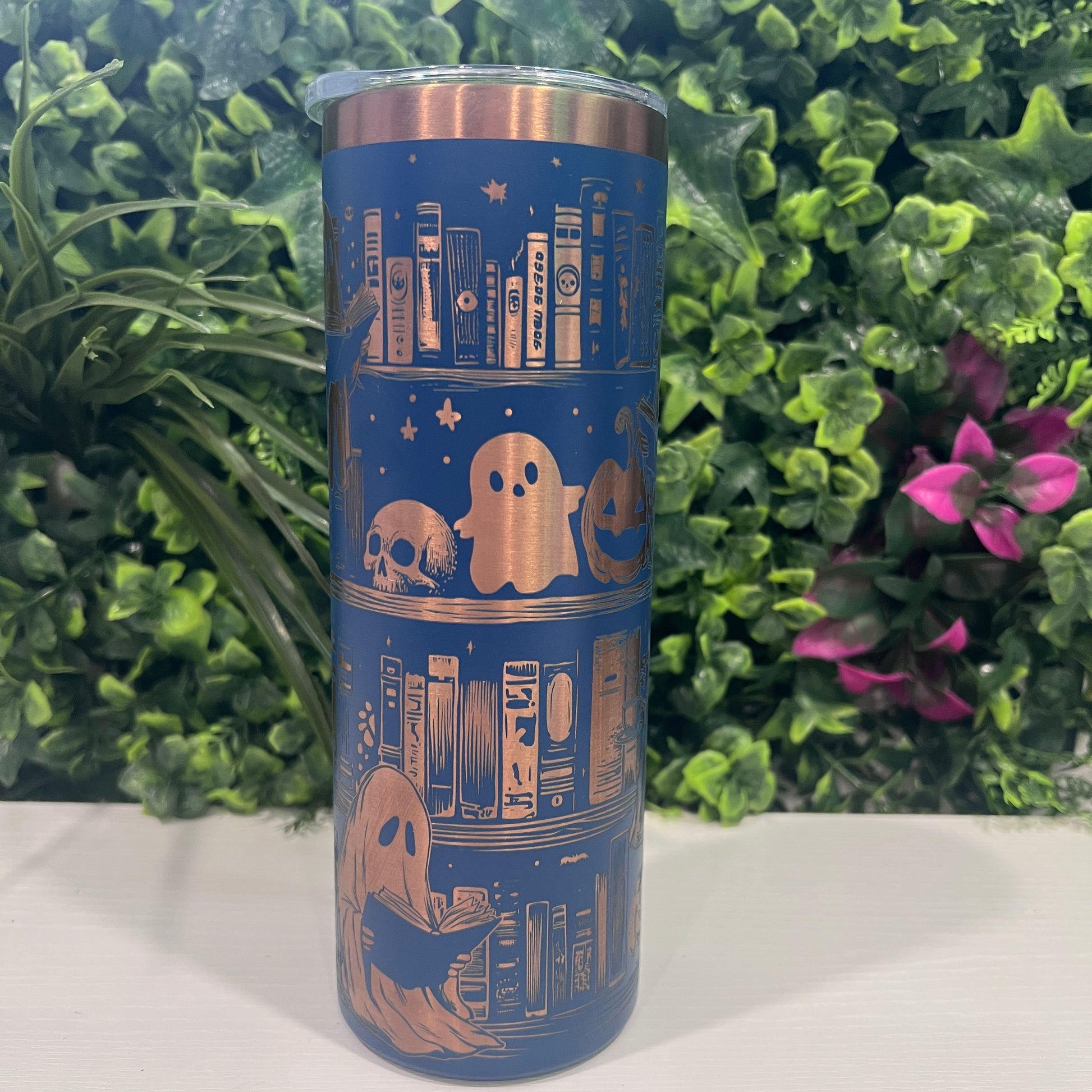 20oz laser engraved skinny tumbler featuring Halloween books, ghosts, bats, and spiderwebs. Perfect spooky drinkware for witchy book lovers and gothic décor fans.