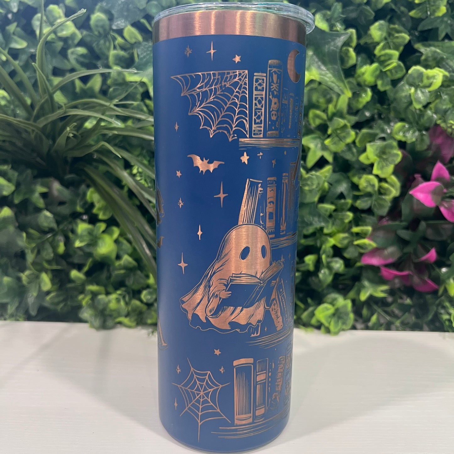 20oz laser engraved skinny tumbler featuring Halloween books, ghosts, bats, and spiderwebs. Perfect spooky drinkware for witchy book lovers and gothic décor fans.