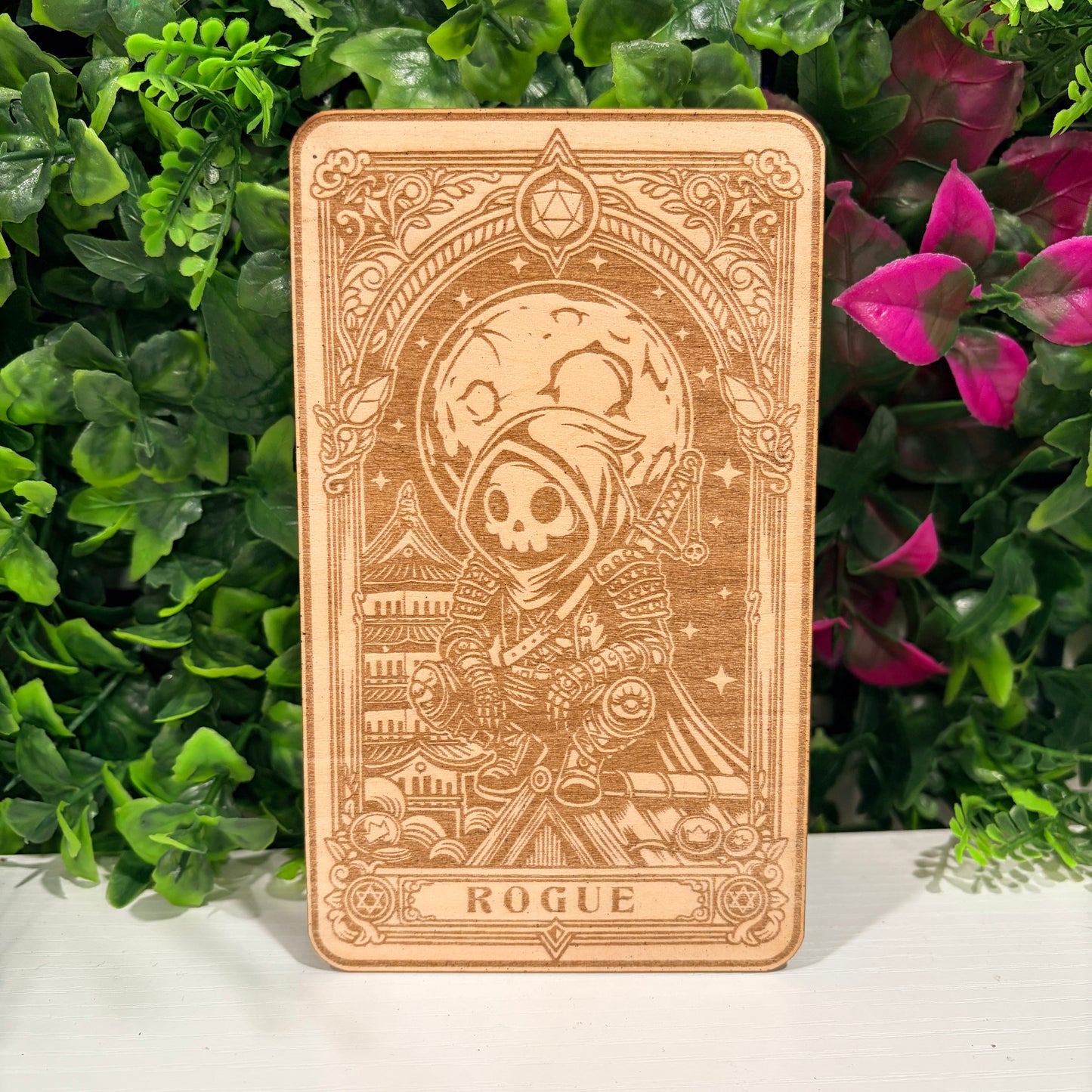 Laser engraved 3mm basswood tarot cards featuring a Rogue class design from Dungeons and Dragons. Intricate fantasy artwork with dice, magic symbols, and ornate gothic detailing.