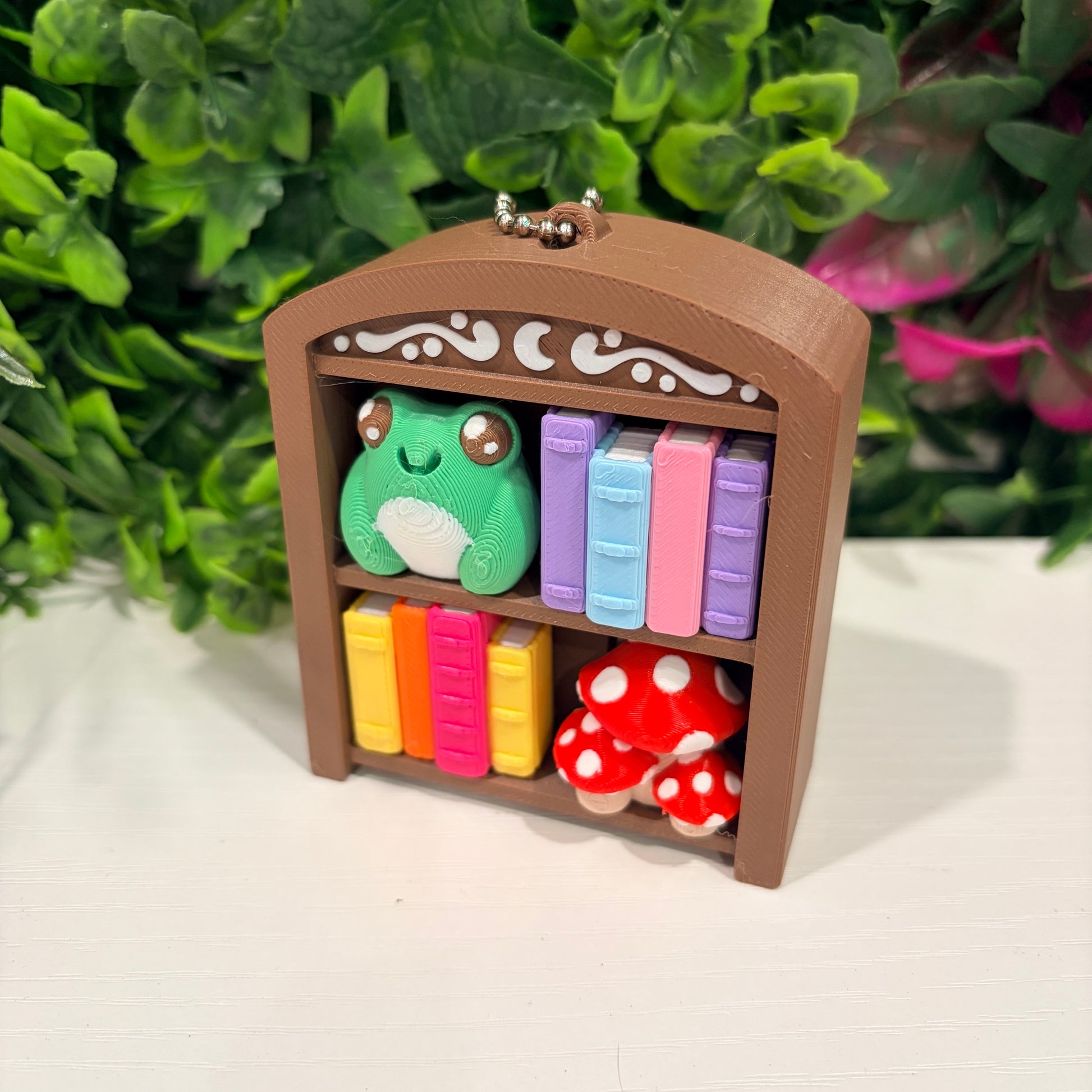4-key bookcase fidget clicker keychain with books, frog, and mushroom.