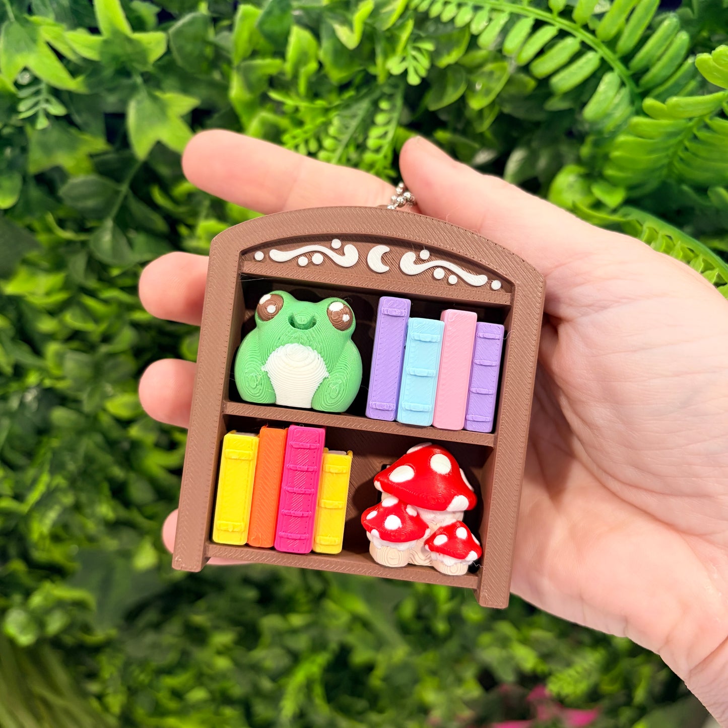 4-key bookcase fidget clicker keychain with books, frog, and mushroom.