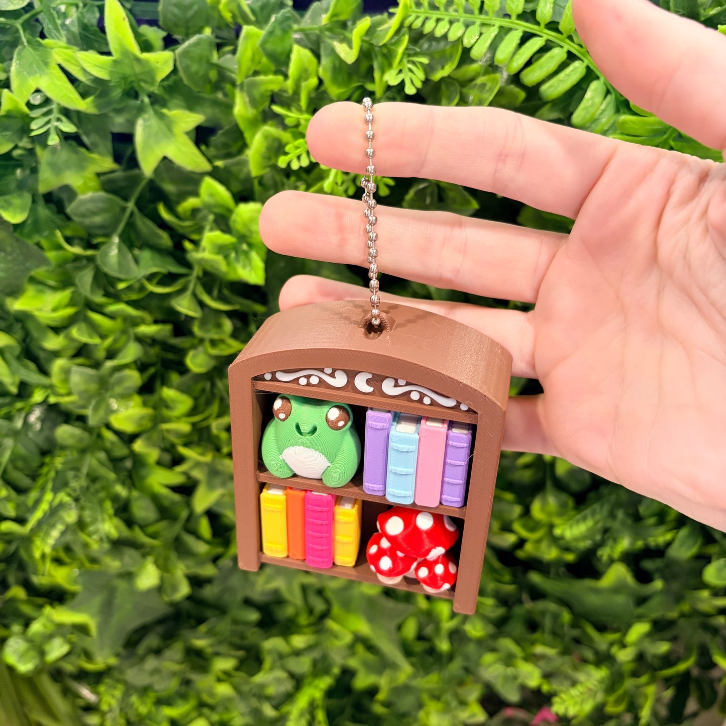 4-key bookcase fidget clicker keychain with books, frog, and mushroom.