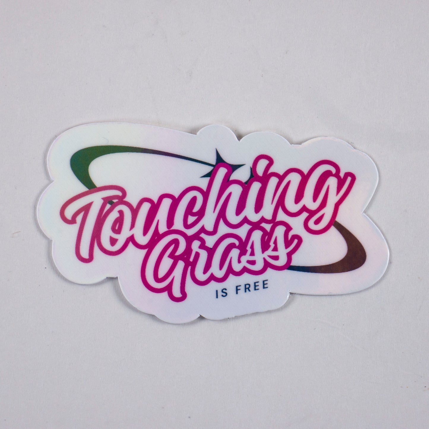 Retro vinyl sticker with “Touching Grass is Free” text in pink and black, perfect for laptops, water bottles, or gamer aesthetics.