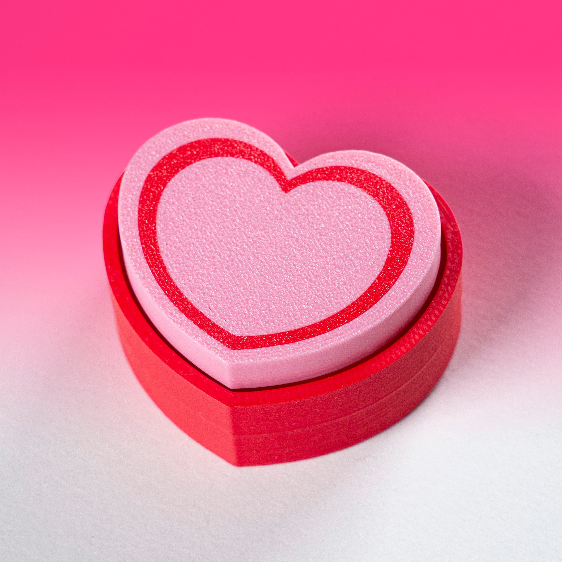 Cute 3D printed heart button clicker in red, perfect for fidgeting, gamer desks, Valentine's gifts, or spreading some love with every satisfying click.