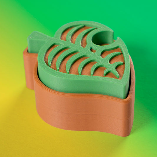 Cute green Animal Crossing leaf-shaped fidget clicker, perfect for gamers and Nintendo fans. Handheld stress relief toy with satisfying click action.