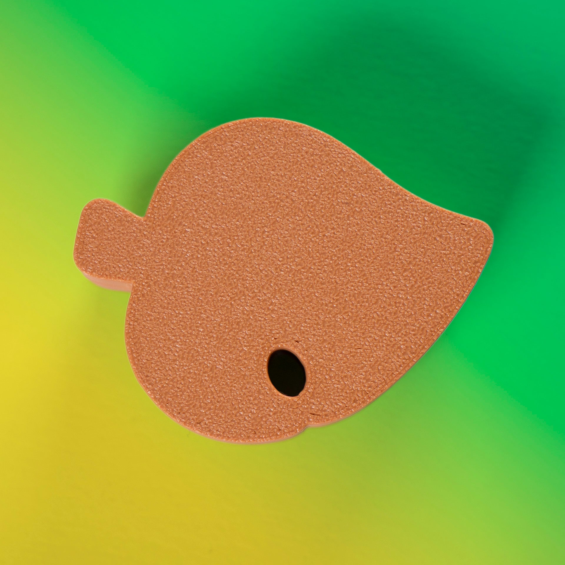 Cute green Animal Crossing leaf-shaped fidget clicker, perfect for gamers and Nintendo fans. Handheld stress relief toy with satisfying click action.