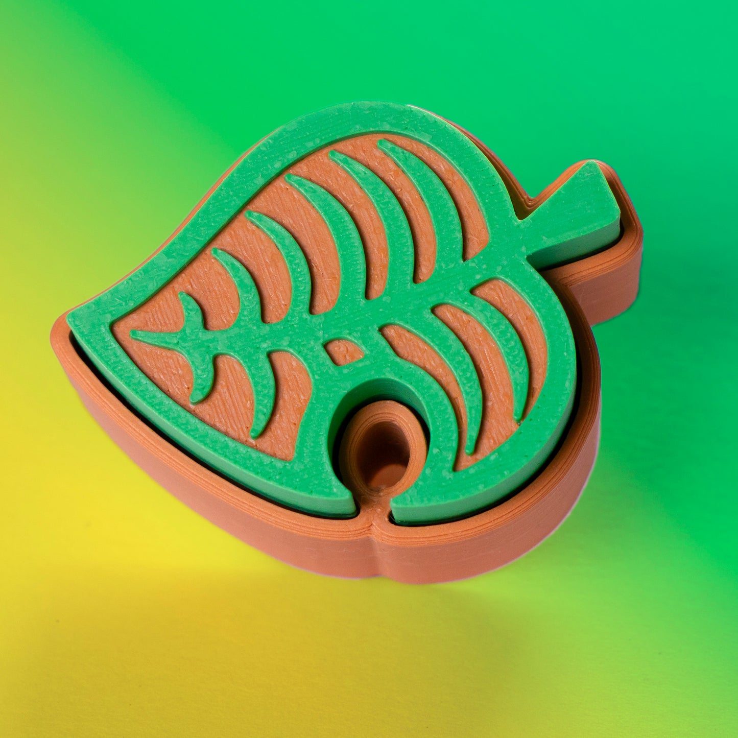 Cute green Animal Crossing leaf-shaped fidget clicker, perfect for gamers and Nintendo fans. Handheld stress relief toy with satisfying click action.