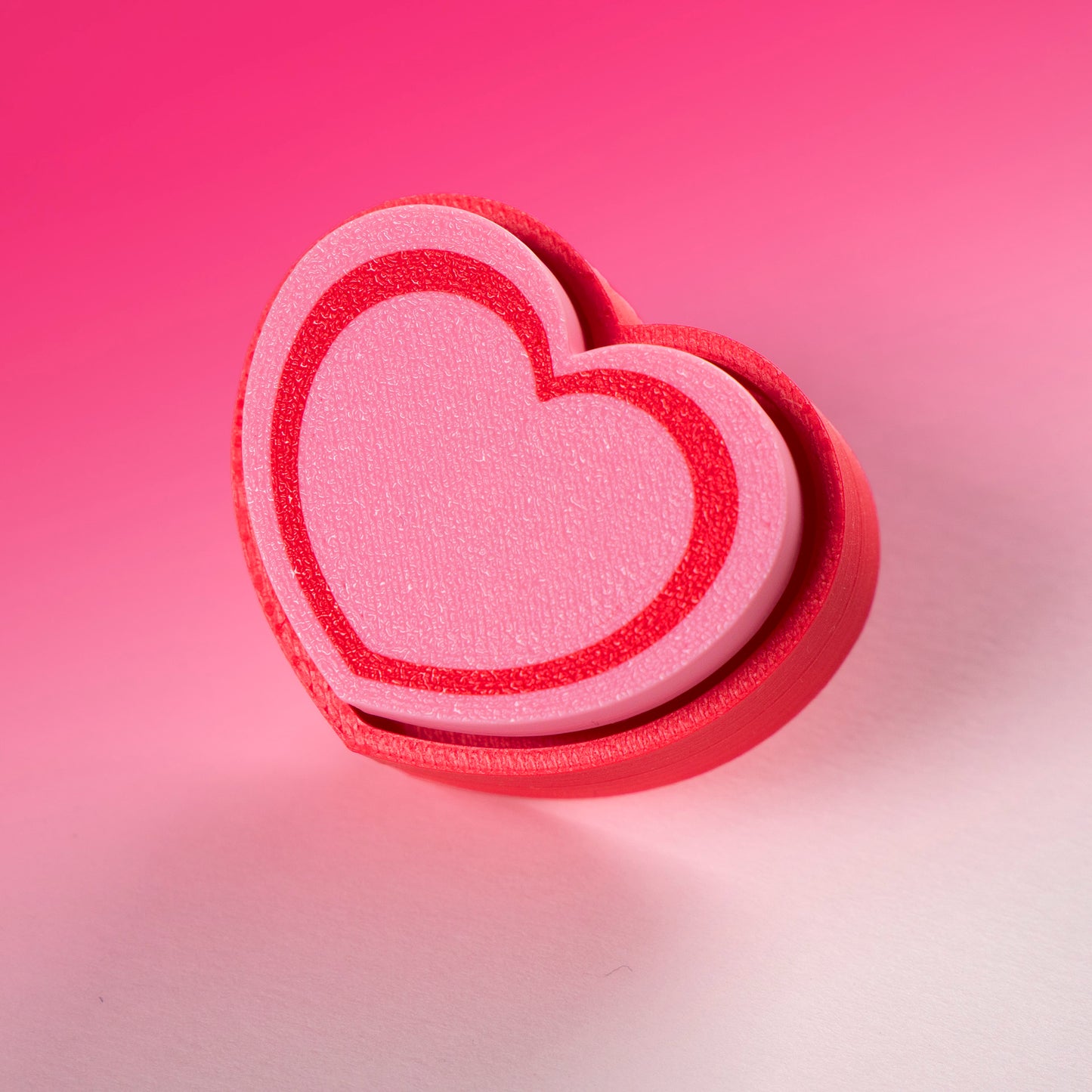Cute 3D printed heart button clicker in red, perfect for fidgeting, gamer desks, Valentine's gifts, or spreading some love with every satisfying click.