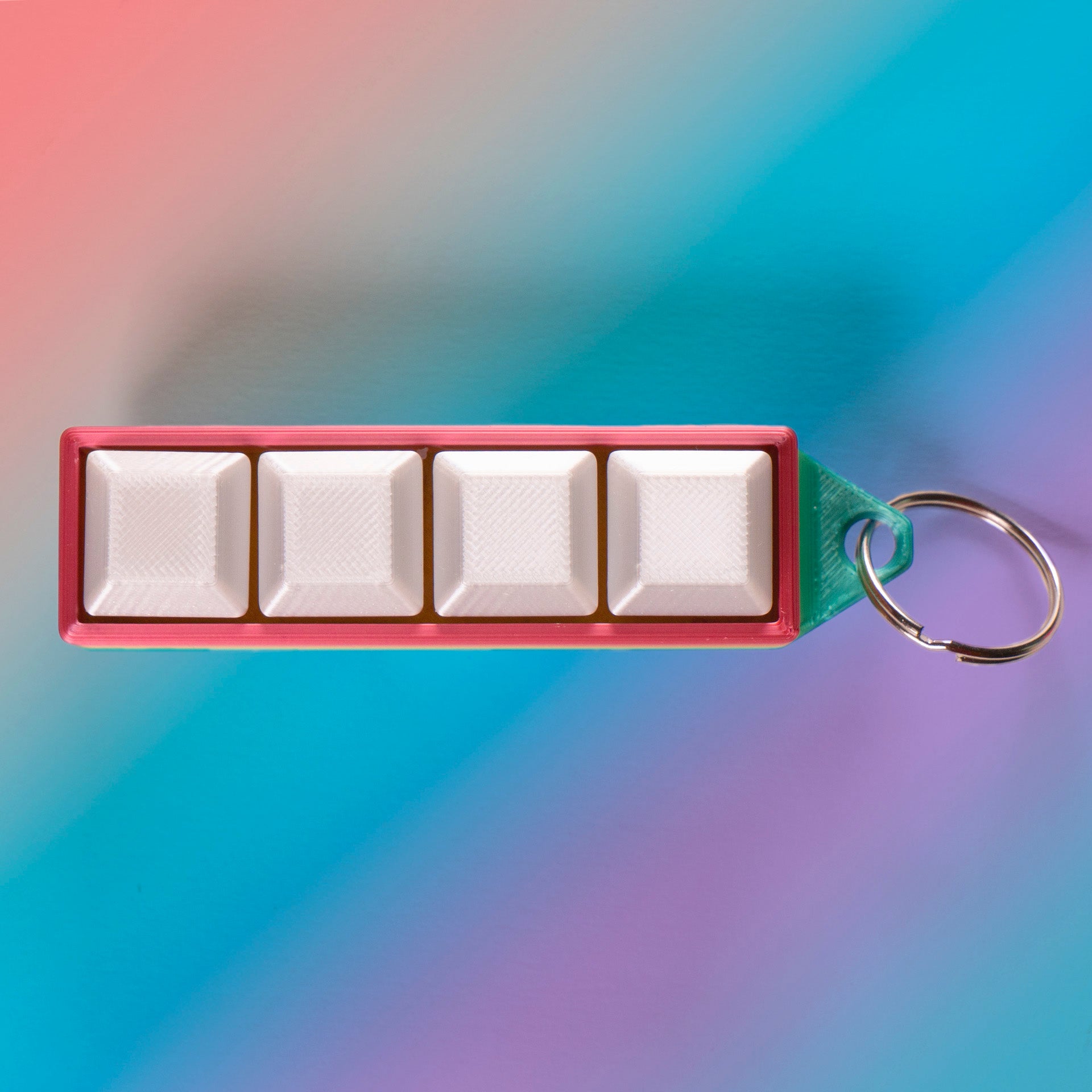 Rainbow 4-key mechanical clicker with white keycaps and keychain loop, perfect for fidgeting, gamer desk setups, or stress relief on the go.