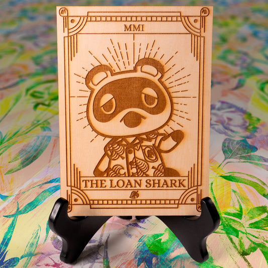 Laser-engraved wooden tarot card featuring Tom Nook as "The Loan Shark." Inspired by Animal Crossing, perfect for gamers, tarot lovers, and collectors. Cottagecore, cozy gaming decor.