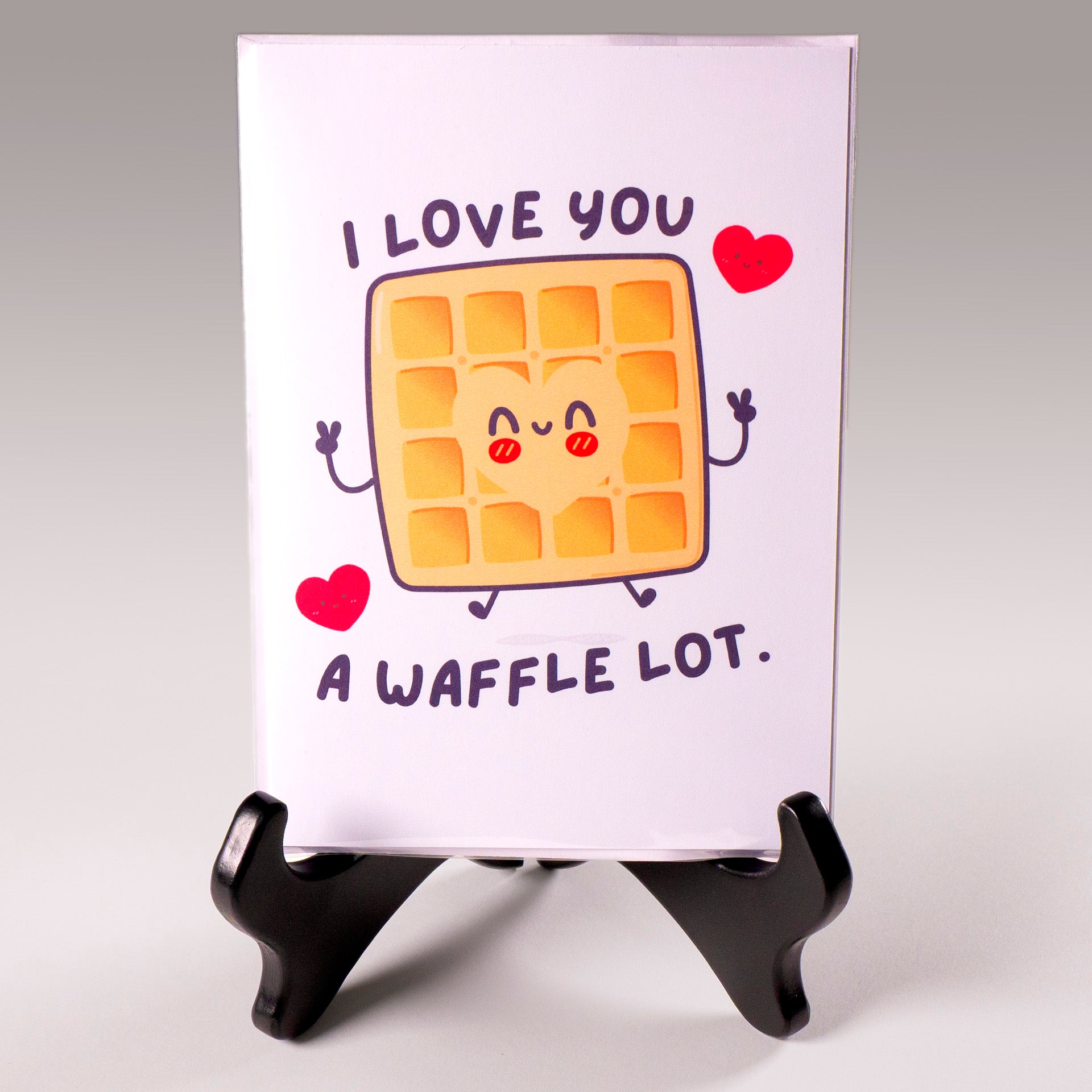Funny kawaii greeting card with a smiling waffle and the pun "I love you a waffle lot." Perfect for anniversaries, Valentine's Day, or sweet love notes.