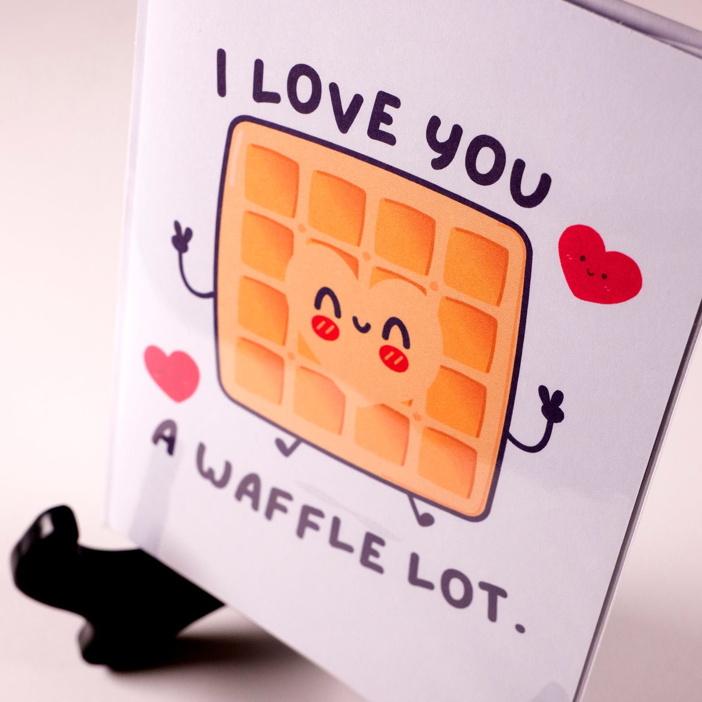 Funny kawaii greeting card with a smiling waffle and the pun "I love you a waffle lot." Perfect for anniversaries, Valentine's Day, or sweet love notes.
