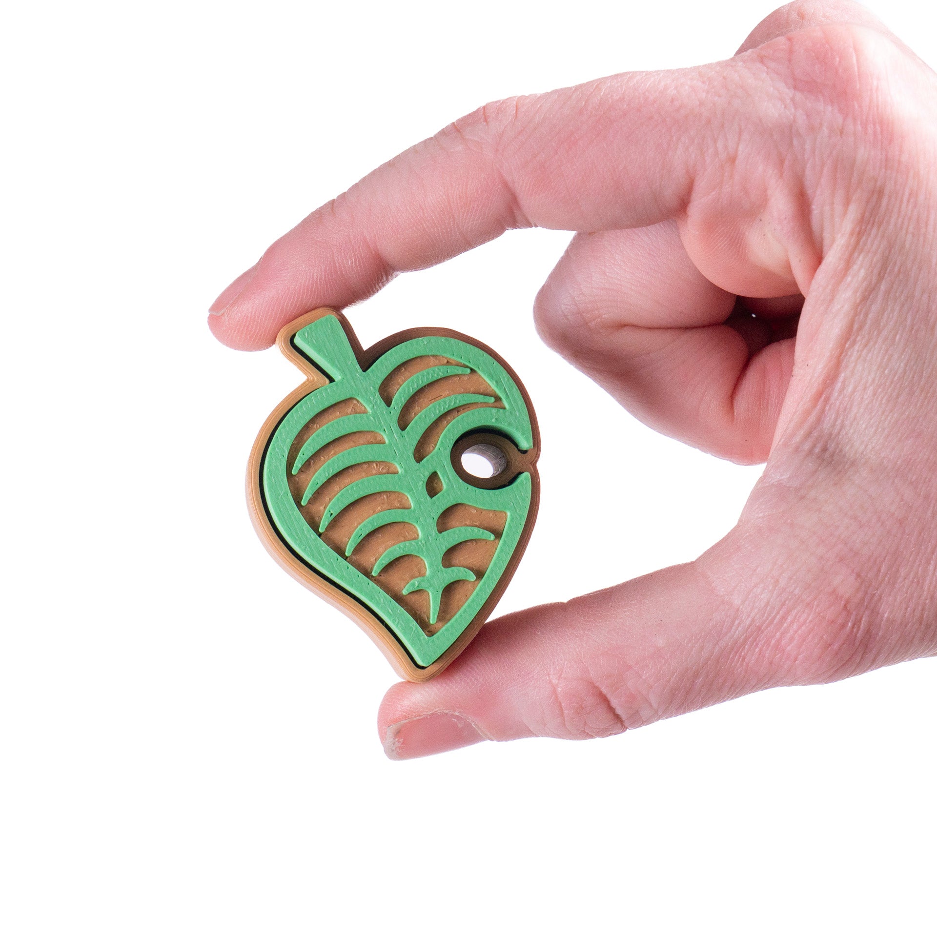 Cute green Animal Crossing leaf-shaped fidget clicker, perfect for gamers and Nintendo fans. Handheld stress relief toy with satisfying click action.