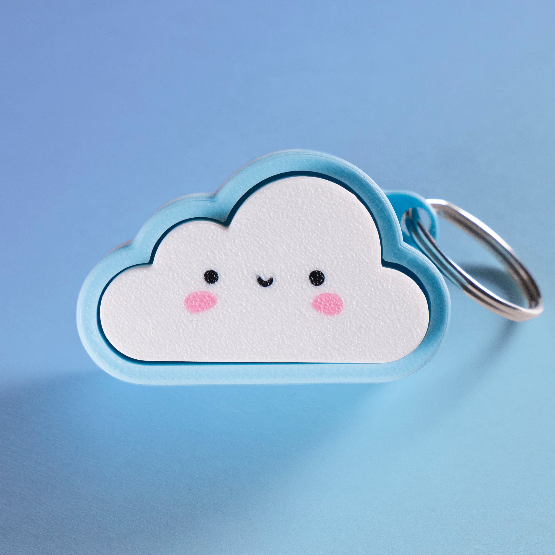 Kawaii cloud fidget clicker keychain with blushing cheeks and a smile, perfect for stress relief, gamer gifts, or cute everyday carry.