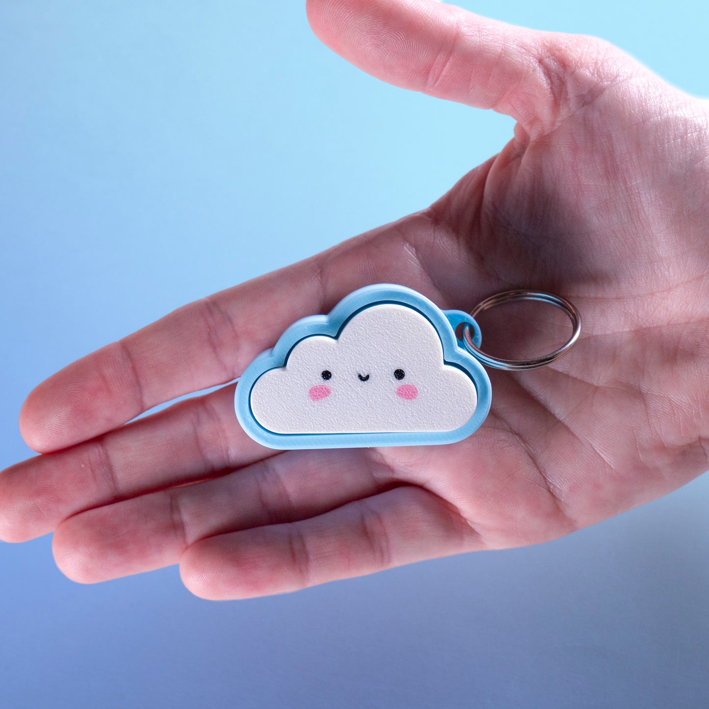 Kawaii cloud fidget clicker keychain with blushing cheeks and a smile, perfect for stress relief, gamer gifts, or cute everyday carry.