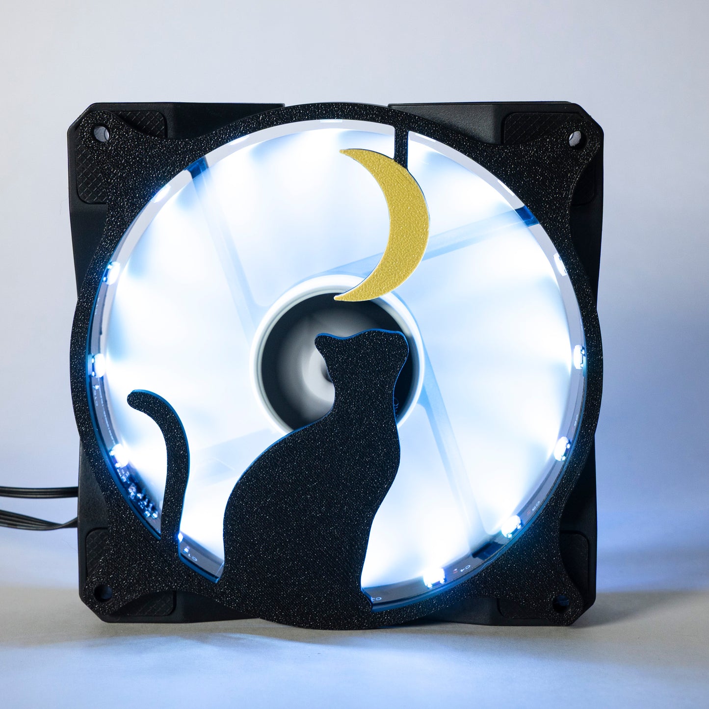 3D printed PC fan grill with a silhouette of a cat gazing at the moon. Perfect for whimsical gaming setups and cat lovers who love custom tech.