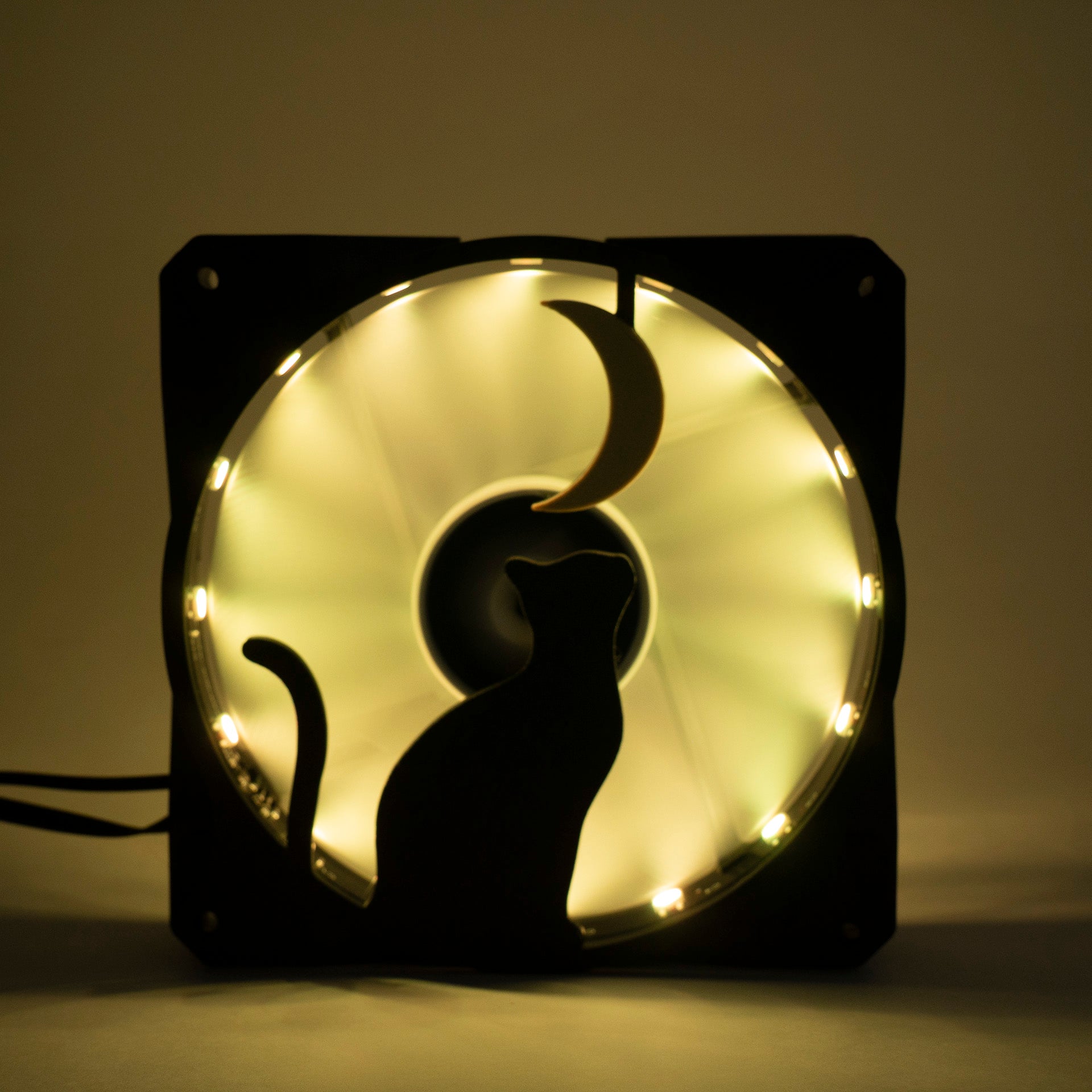 3D printed PC fan grill with a silhouette of a cat gazing at the moon. Perfect for whimsical gaming setups and cat lovers who love custom tech.