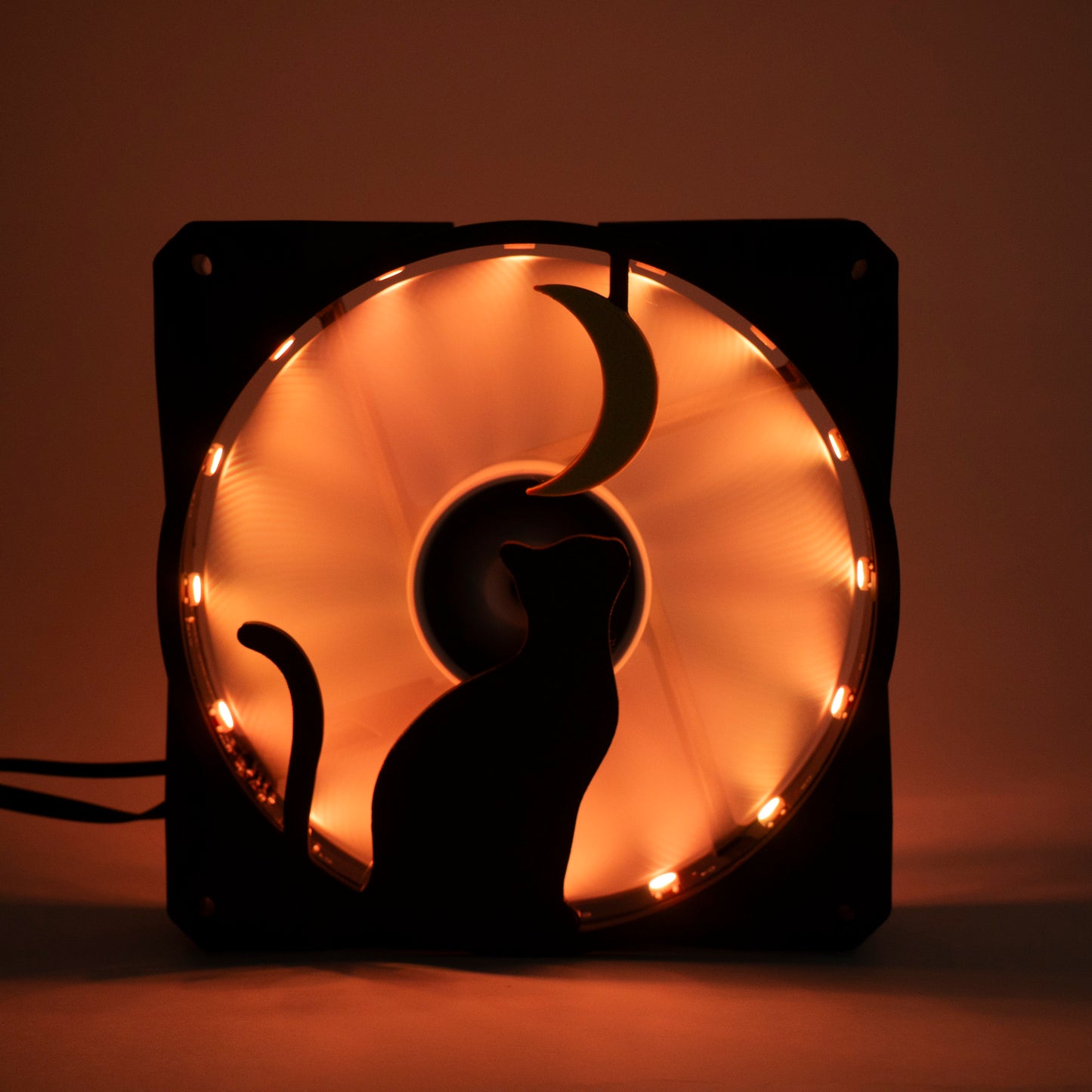 3D printed PC fan grill with a silhouette of a cat gazing at the moon. Perfect for whimsical gaming setups and cat lovers who love custom tech.