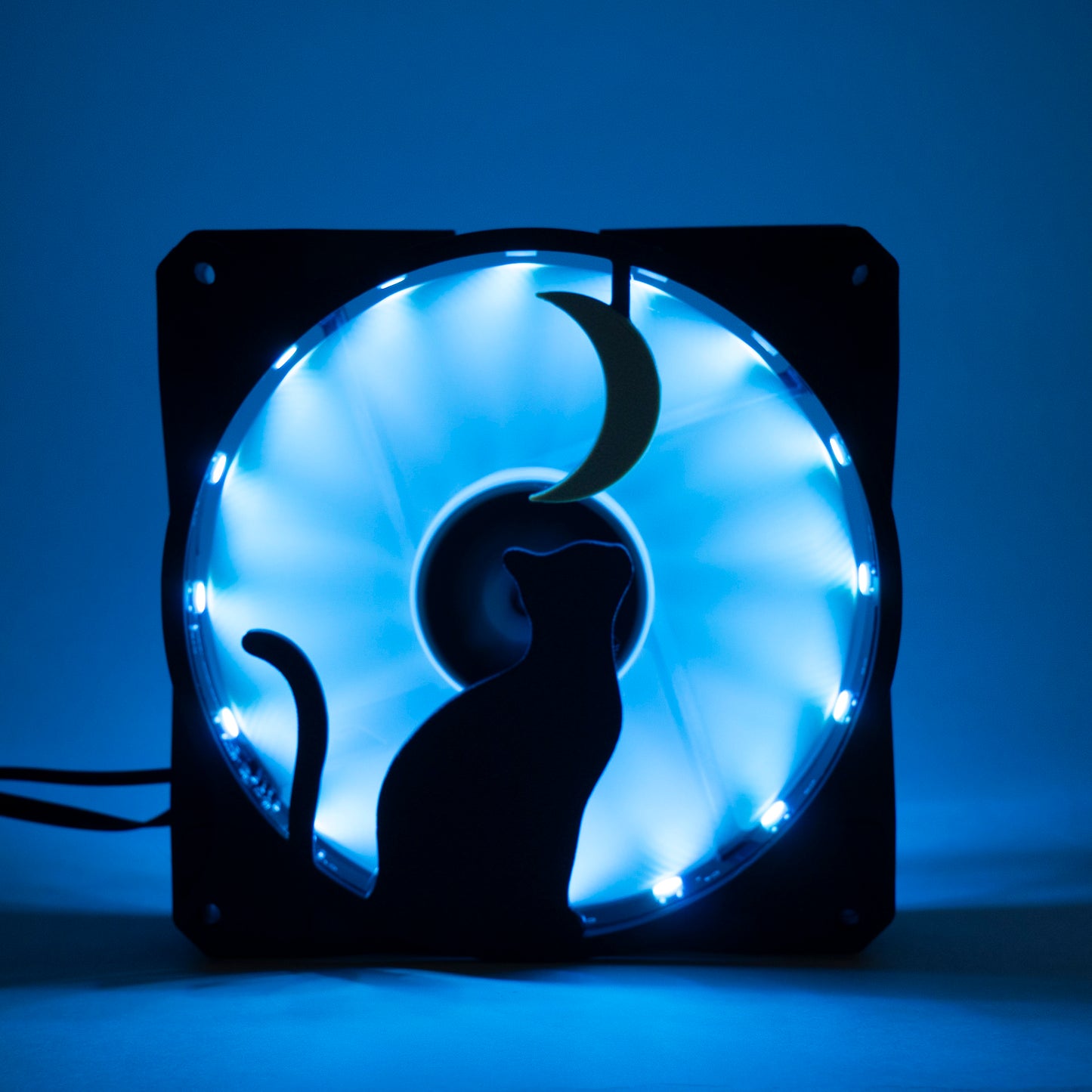 3D printed PC fan grill with a silhouette of a cat gazing at the moon. Perfect for whimsical gaming setups and cat lovers who love custom tech.