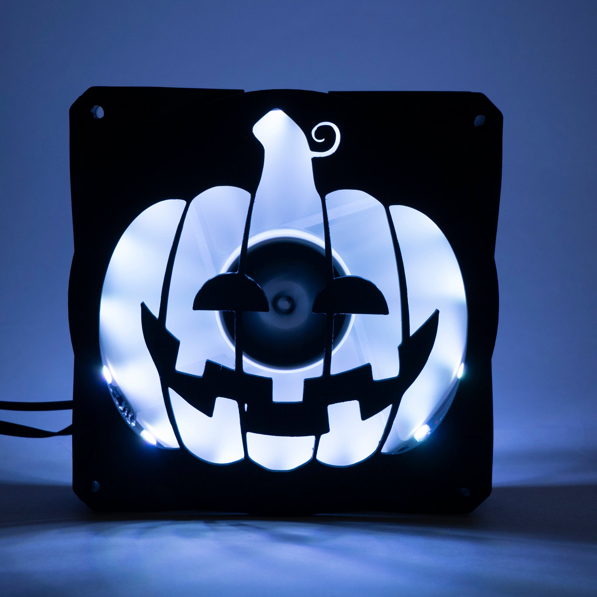 3D printed PC fan grill shaped like a spooky jack-o'-lantern pumpkin. Perfect Halloween-themed case mod for gamers and tech lovers.