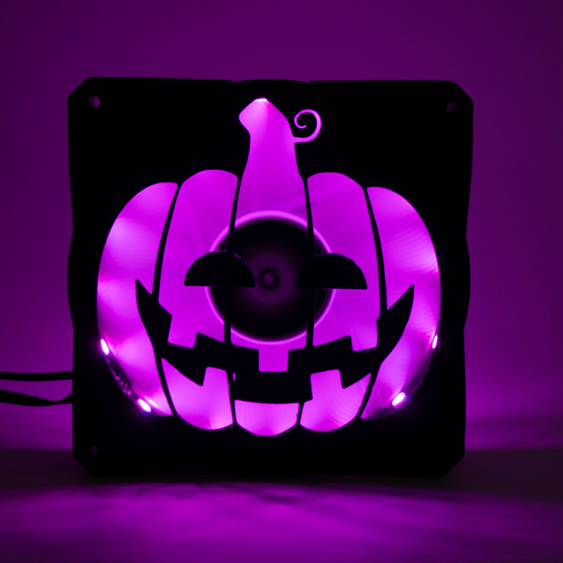 3D printed PC fan grill shaped like a spooky jack-o'-lantern pumpkin. Perfect Halloween-themed case mod for gamers and tech lovers.