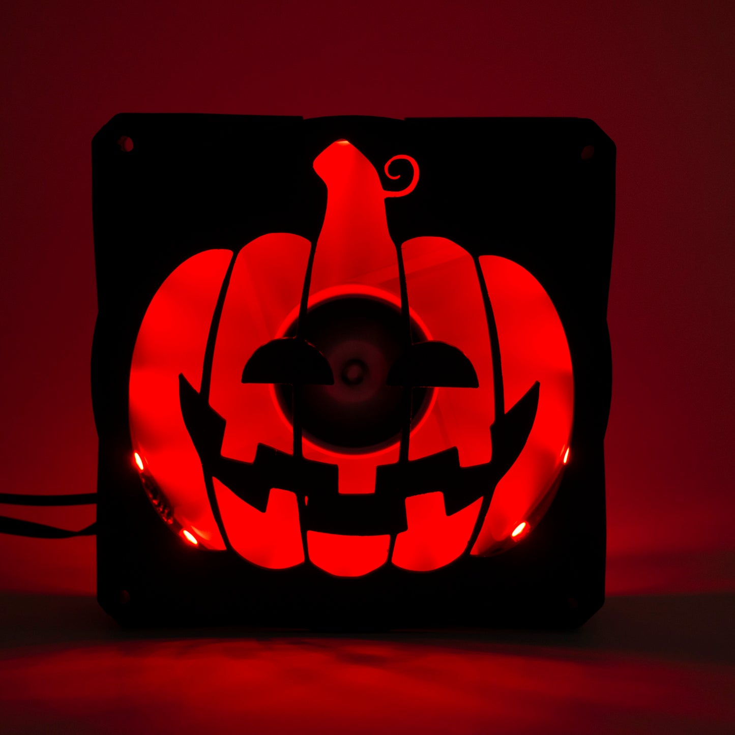3D printed PC fan grill shaped like a spooky jack-o'-lantern pumpkin. Perfect Halloween-themed case mod for gamers and tech lovers.