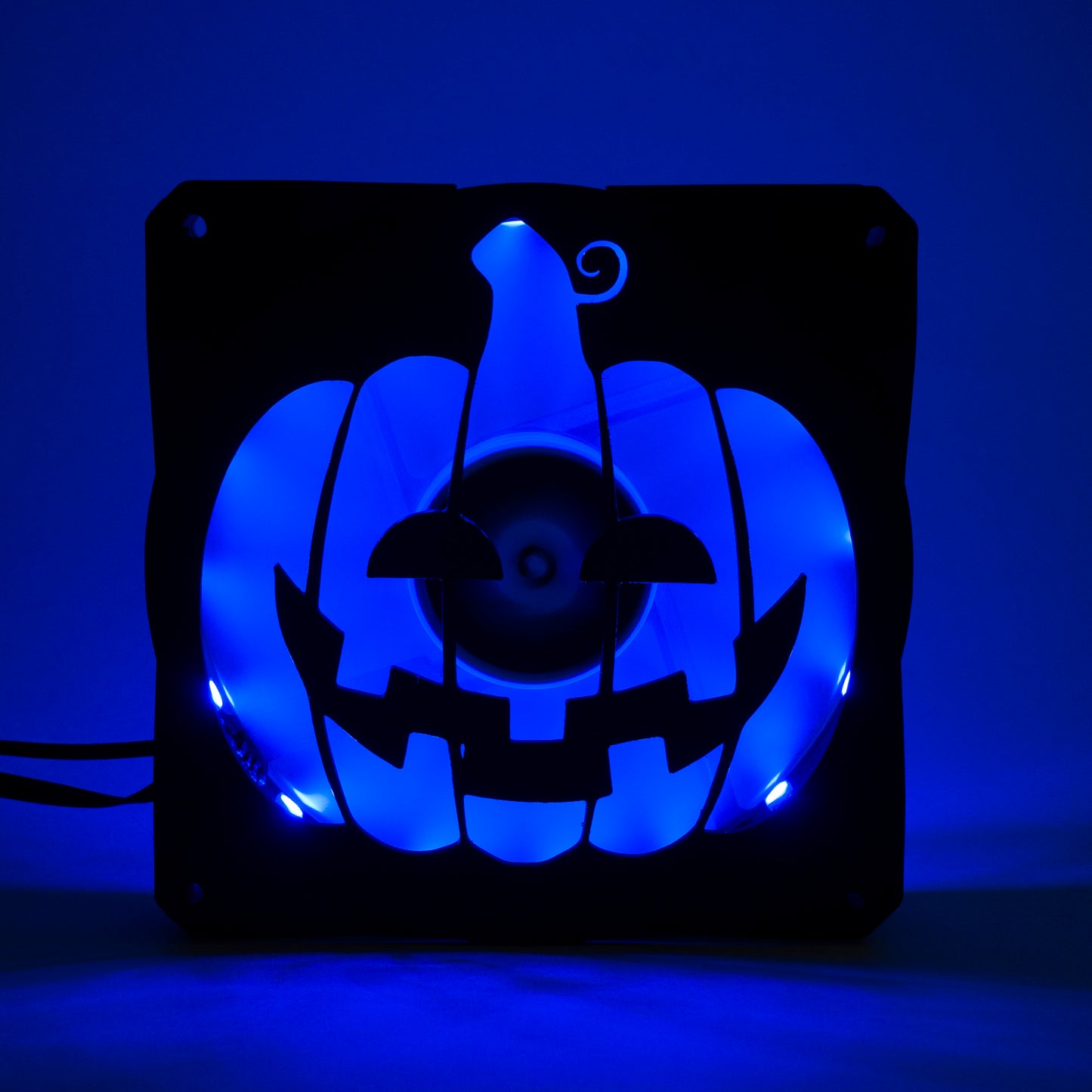 3D printed PC fan grill shaped like a spooky jack-o'-lantern pumpkin. Perfect Halloween-themed case mod for gamers and tech lovers.