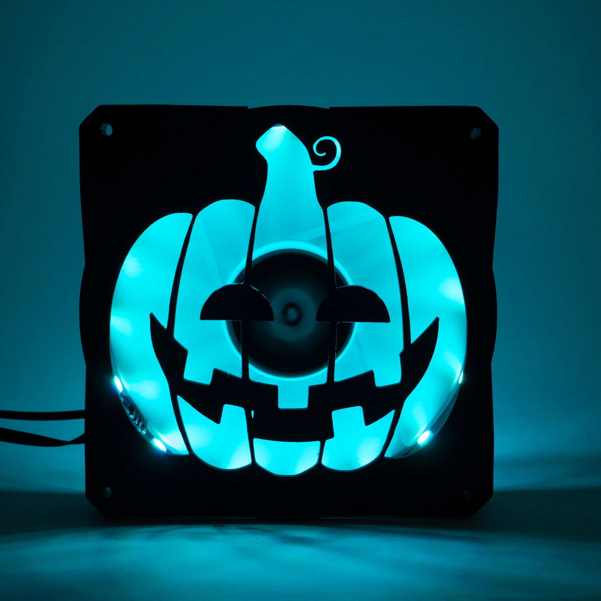 3D printed PC fan grill shaped like a spooky jack-o'-lantern pumpkin. Perfect Halloween-themed case mod for gamers and tech lovers.