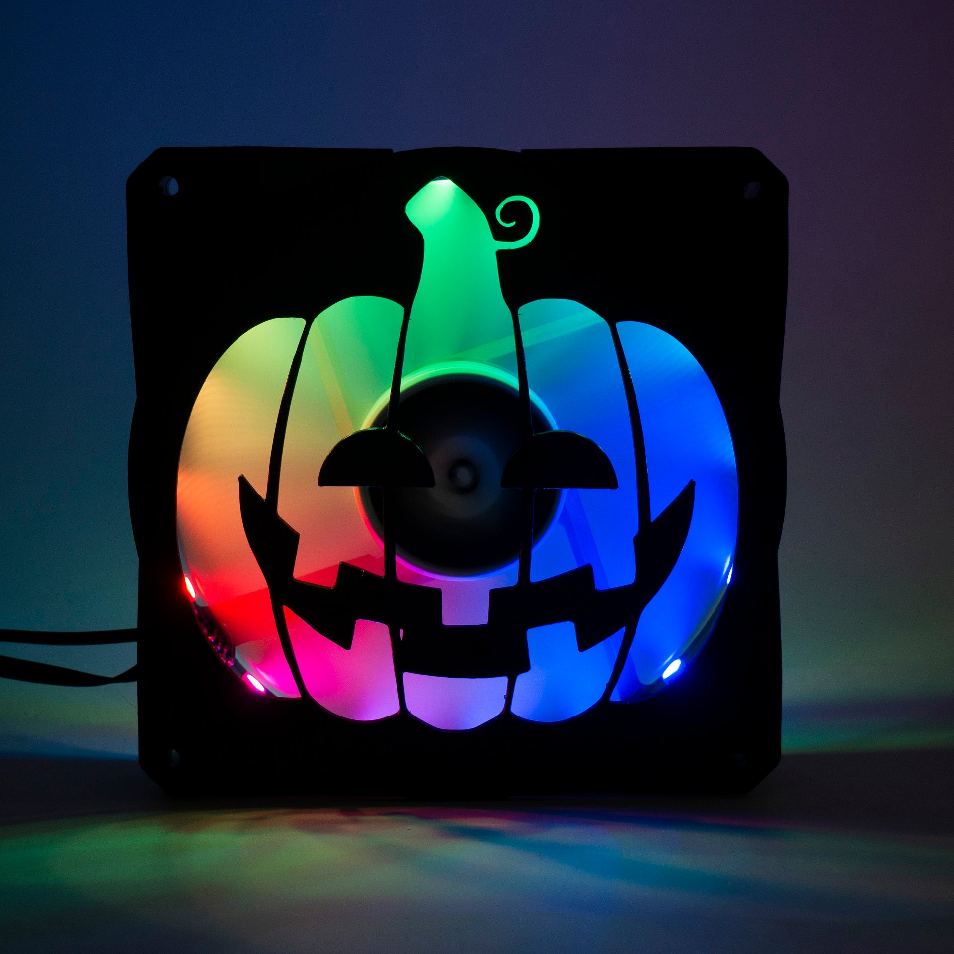 3D printed PC fan grill shaped like a spooky jack-o'-lantern pumpkin. Perfect Halloween-themed case mod for gamers and tech lovers.