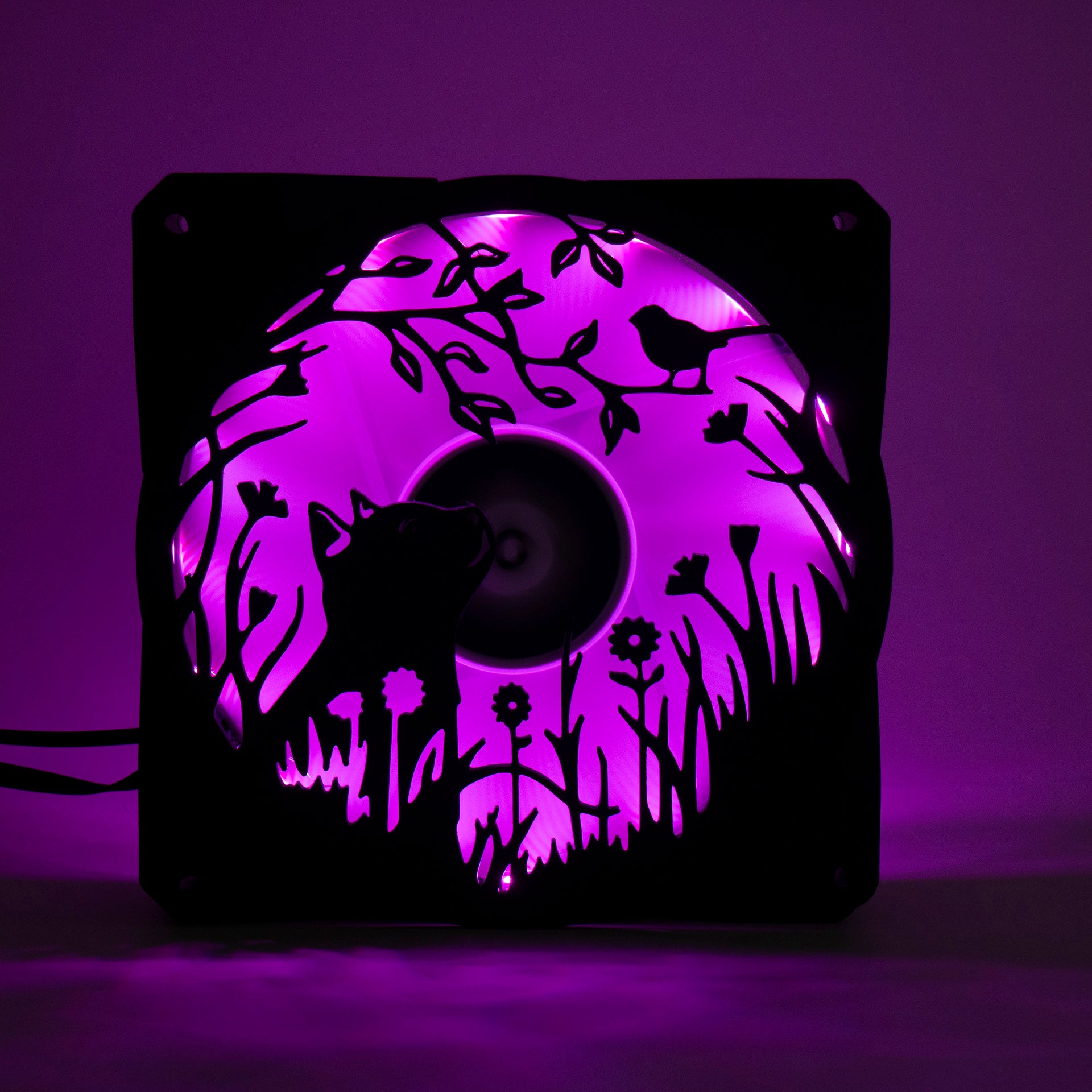 Adorable 3D printed PC fan grill featuring a cat and bird in a garden scene. Adds cozy charm and personality to any gaming or desktop setup.