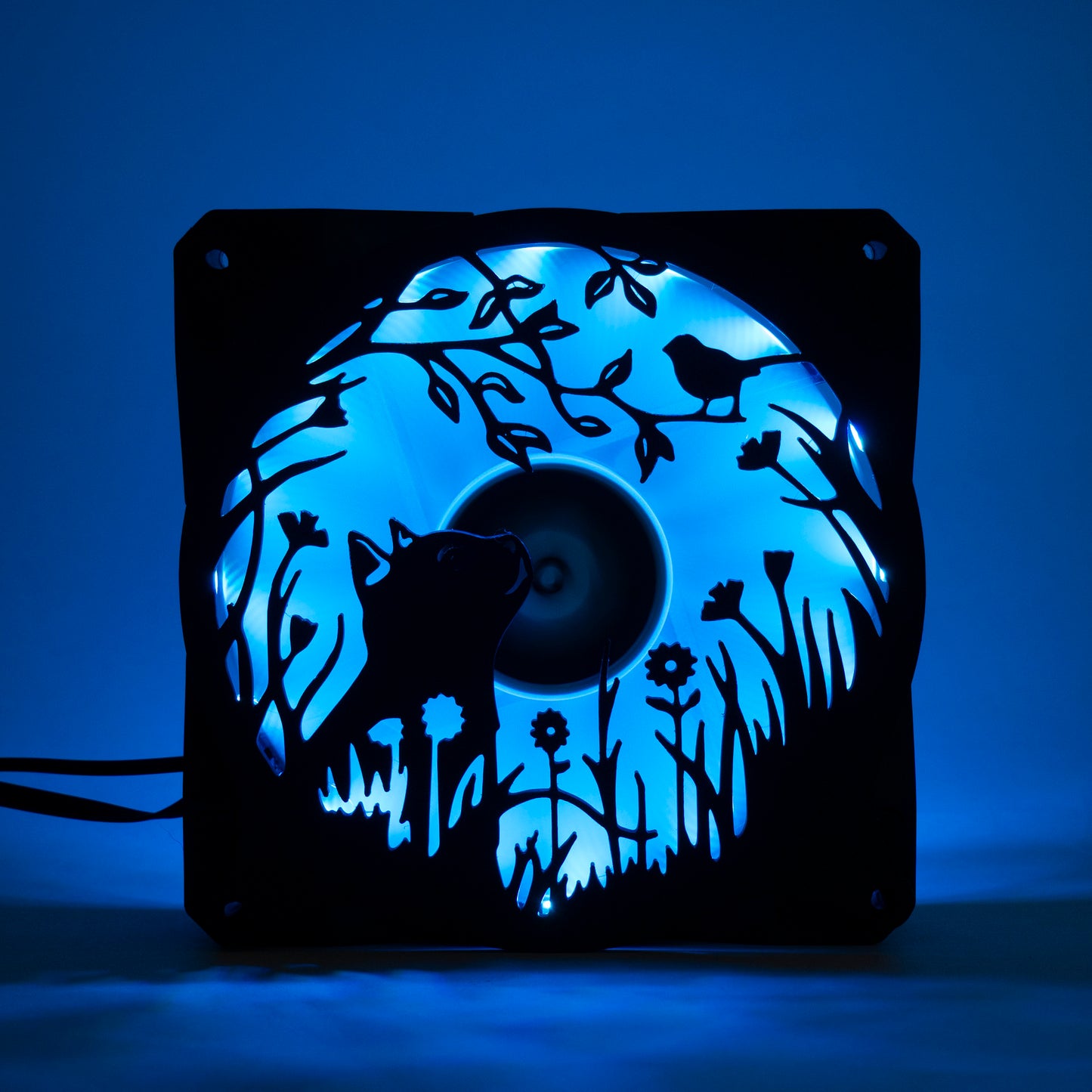 Adorable 3D printed PC fan grill featuring a cat and bird in a garden scene. Adds cozy charm and personality to any gaming or desktop setup.