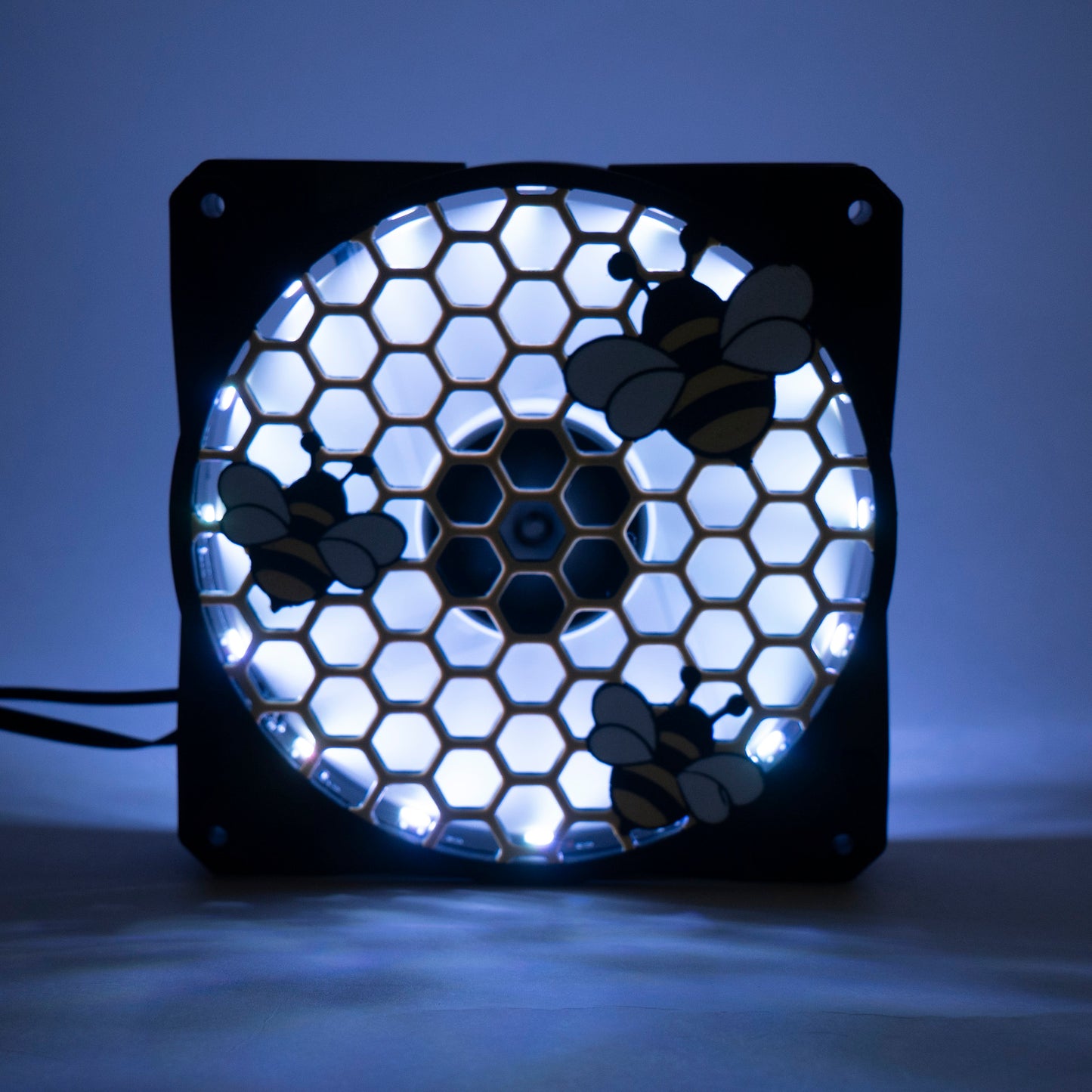 Adorable 3D printed PC fan grill featuring bees and honeycomb. Perfect for customizing aesthetic gamer setups with a cute, nature-inspired design.