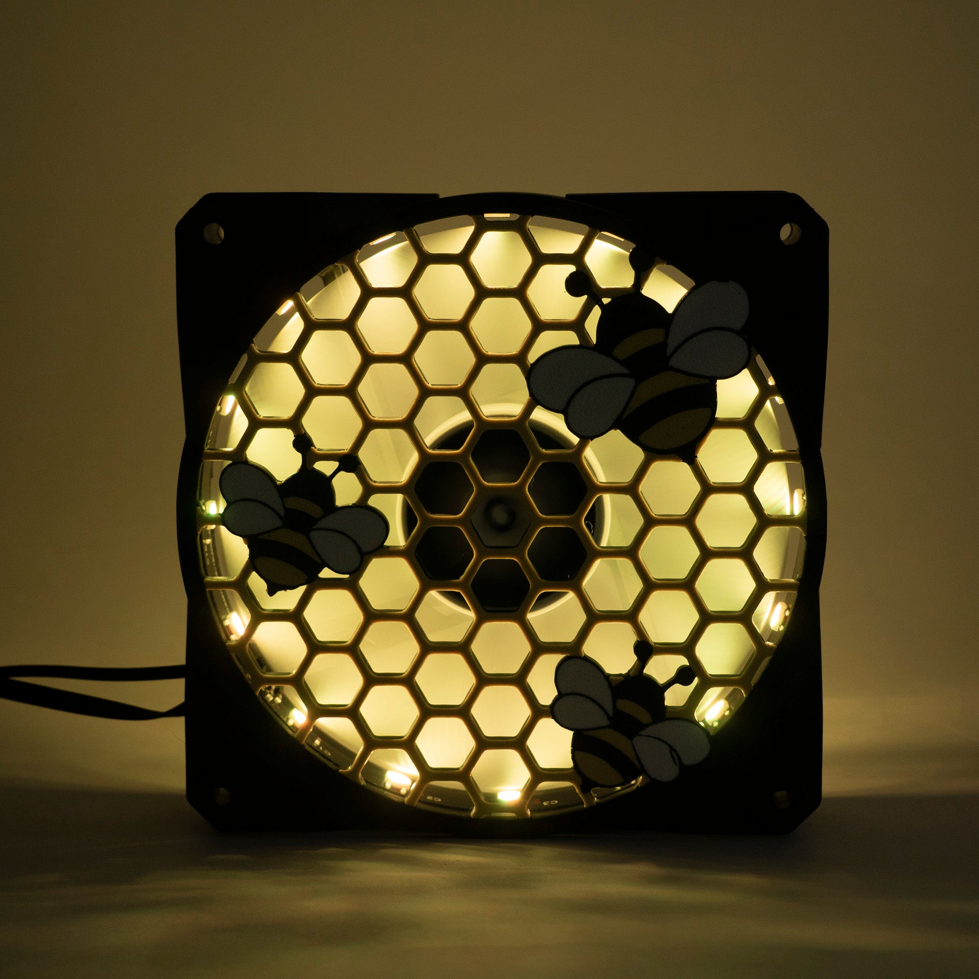 Adorable 3D printed PC fan grill featuring bees and honeycomb. Perfect for customizing aesthetic gamer setups with a cute, nature-inspired design.