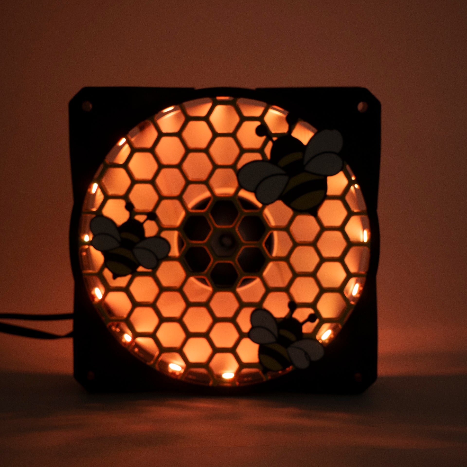 Adorable 3D printed PC fan grill featuring bees and honeycomb. Perfect for customizing aesthetic gamer setups with a cute, nature-inspired design.