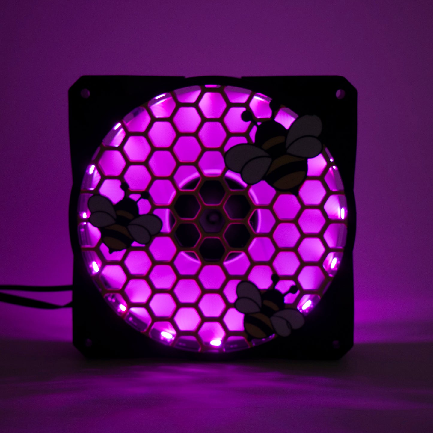 Adorable 3D printed PC fan grill featuring bees and honeycomb. Perfect for customizing aesthetic gamer setups with a cute, nature-inspired design.