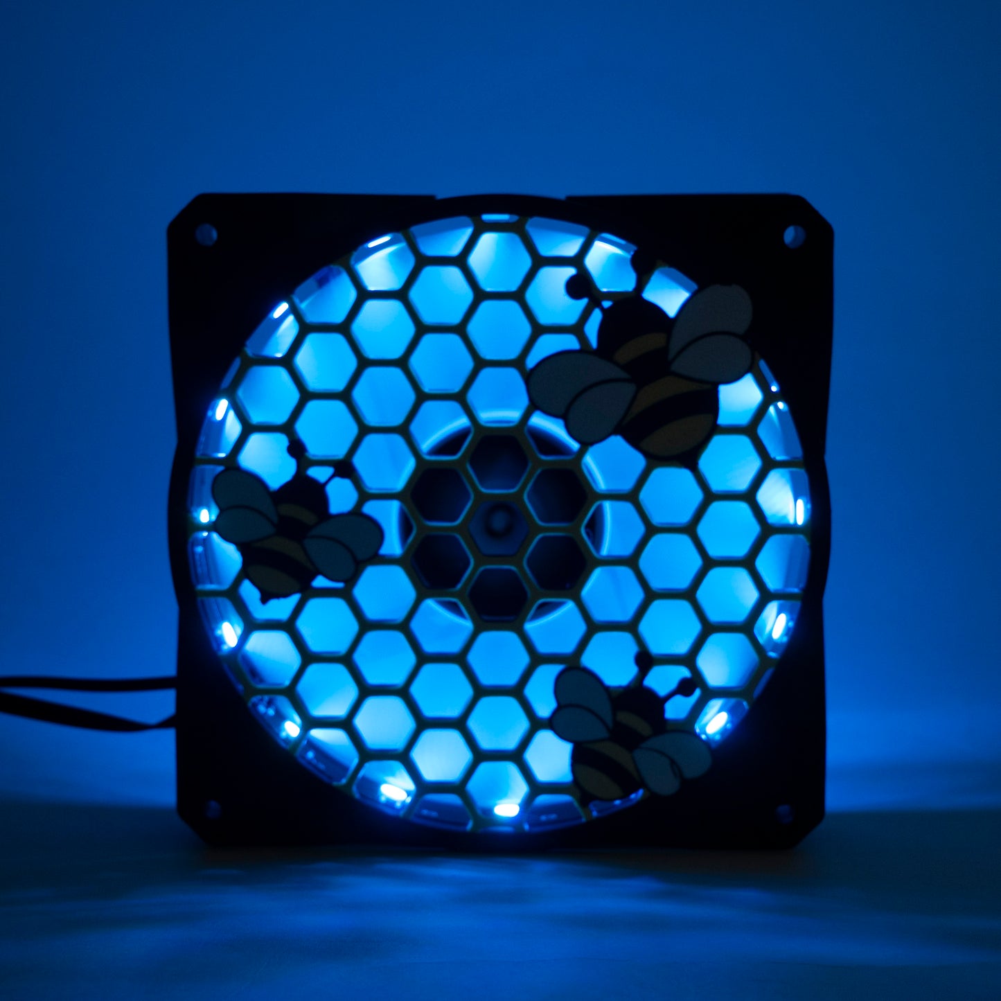 Adorable 3D printed PC fan grill featuring bees and honeycomb. Perfect for customizing aesthetic gamer setups with a cute, nature-inspired design.