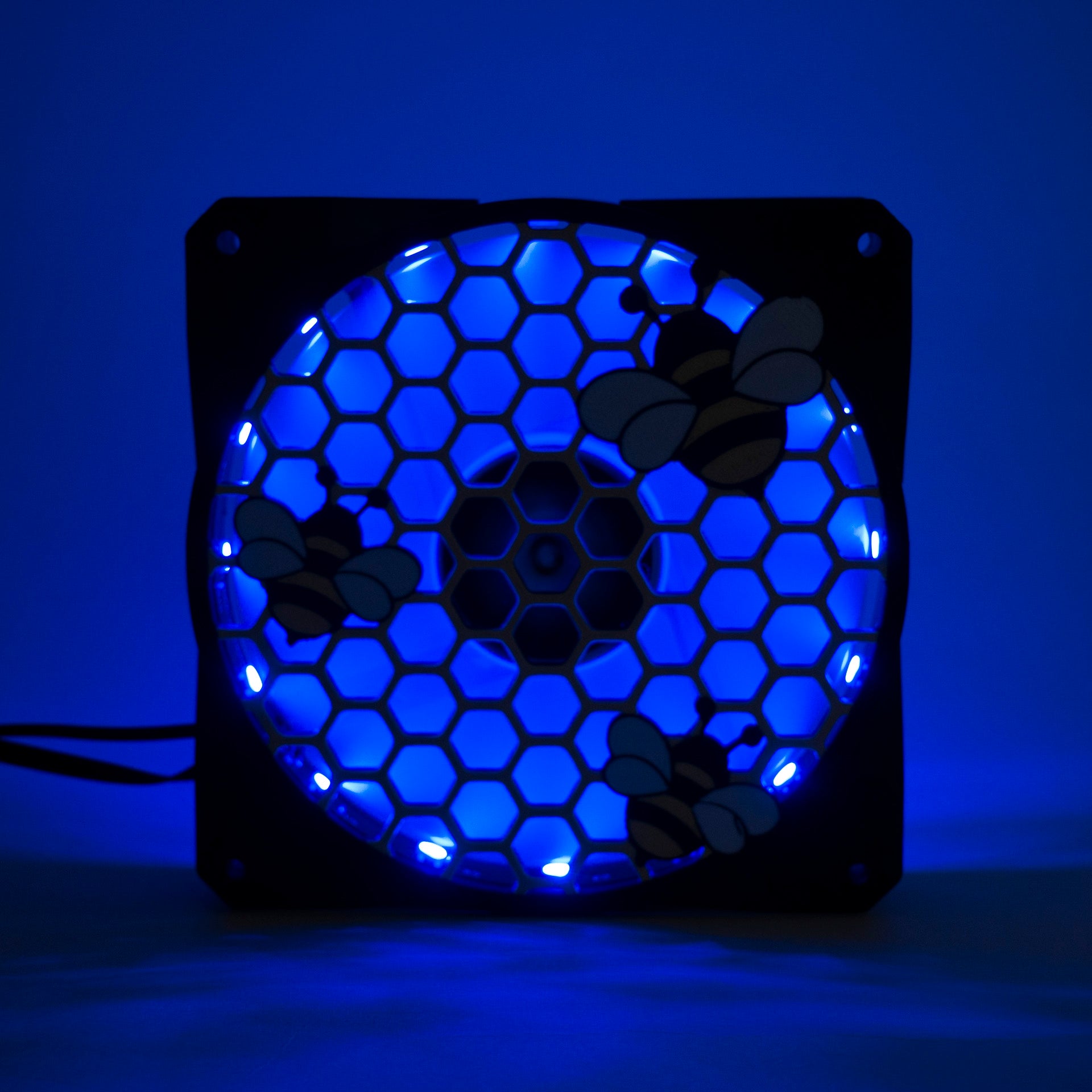 Adorable 3D printed PC fan grill featuring bees and honeycomb. Perfect for customizing aesthetic gamer setups with a cute, nature-inspired design.