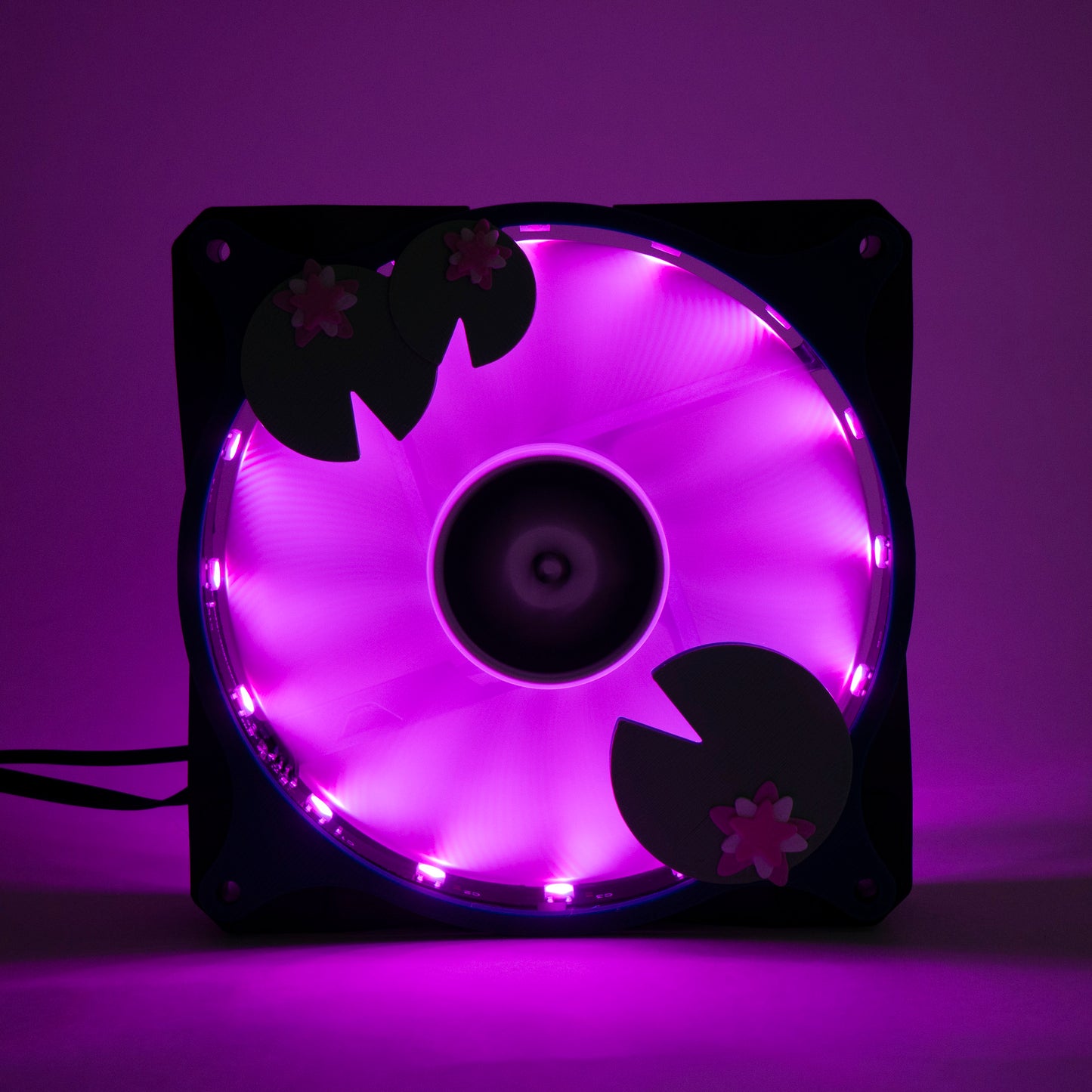Adorable 3D printed PC fan grill with lily pad and lotus flower design. A cute nature-inspired fan cover perfect for cozy, aesthetic gaming setups.