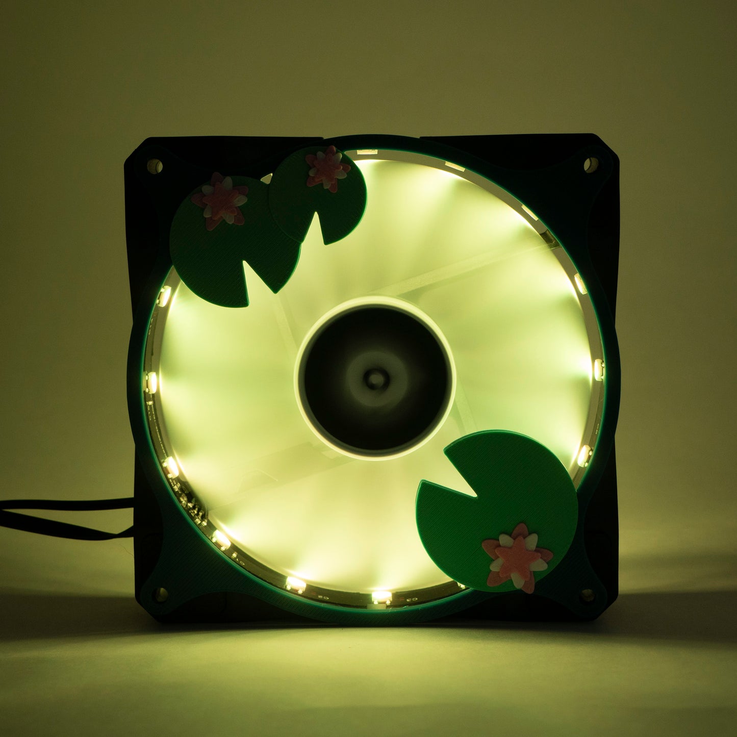 Adorable 3D printed PC fan grill with lily pad and lotus flower design. A cute nature-inspired fan cover perfect for cozy, aesthetic gaming setups.