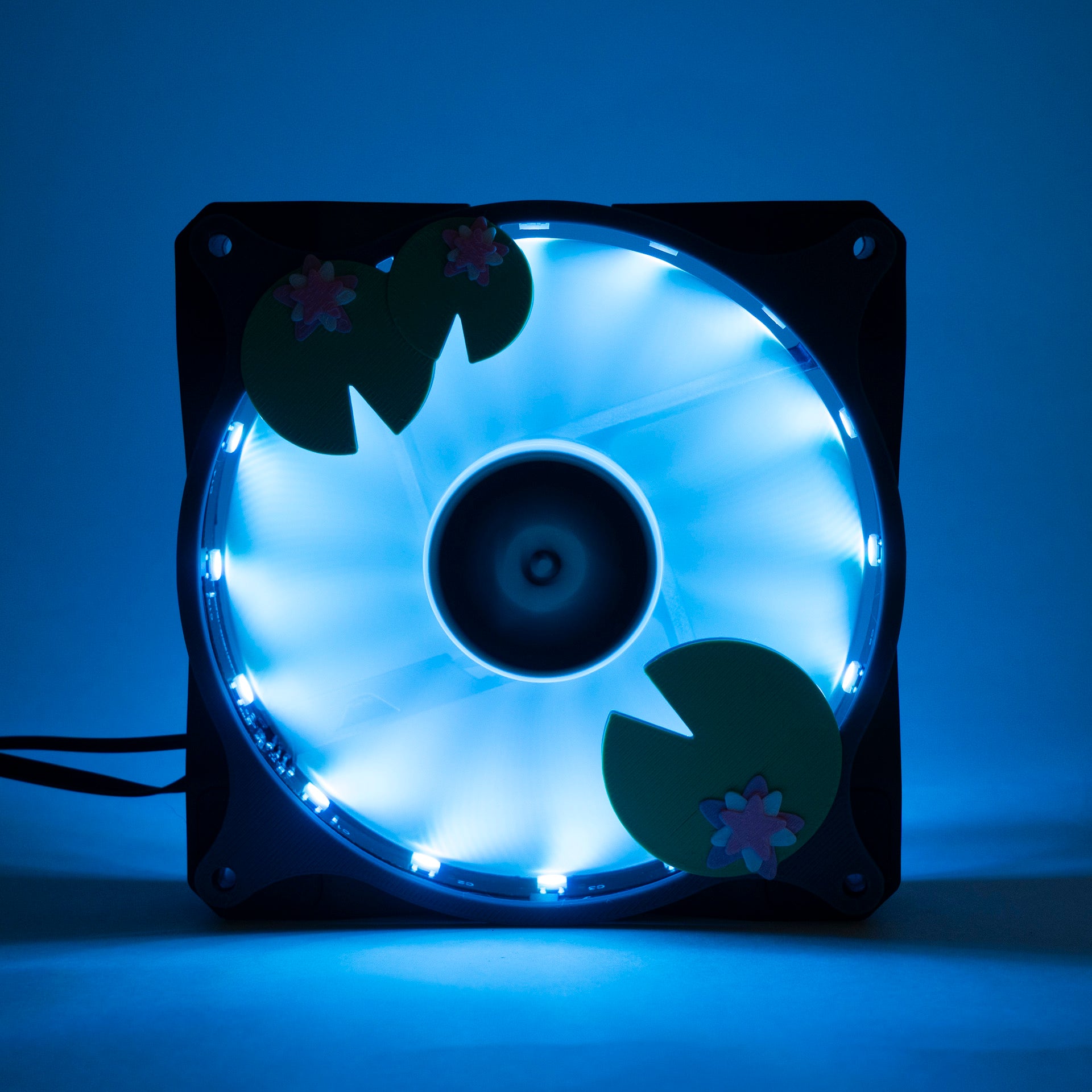 Adorable 3D printed PC fan grill with lily pad and lotus flower design. A cute nature-inspired fan cover perfect for cozy, aesthetic gaming setups.