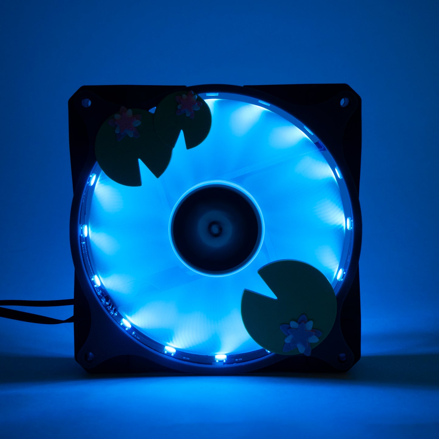 Adorable 3D printed PC fan grill with lily pad and lotus flower design. A cute nature-inspired fan cover perfect for cozy, aesthetic gaming setups.