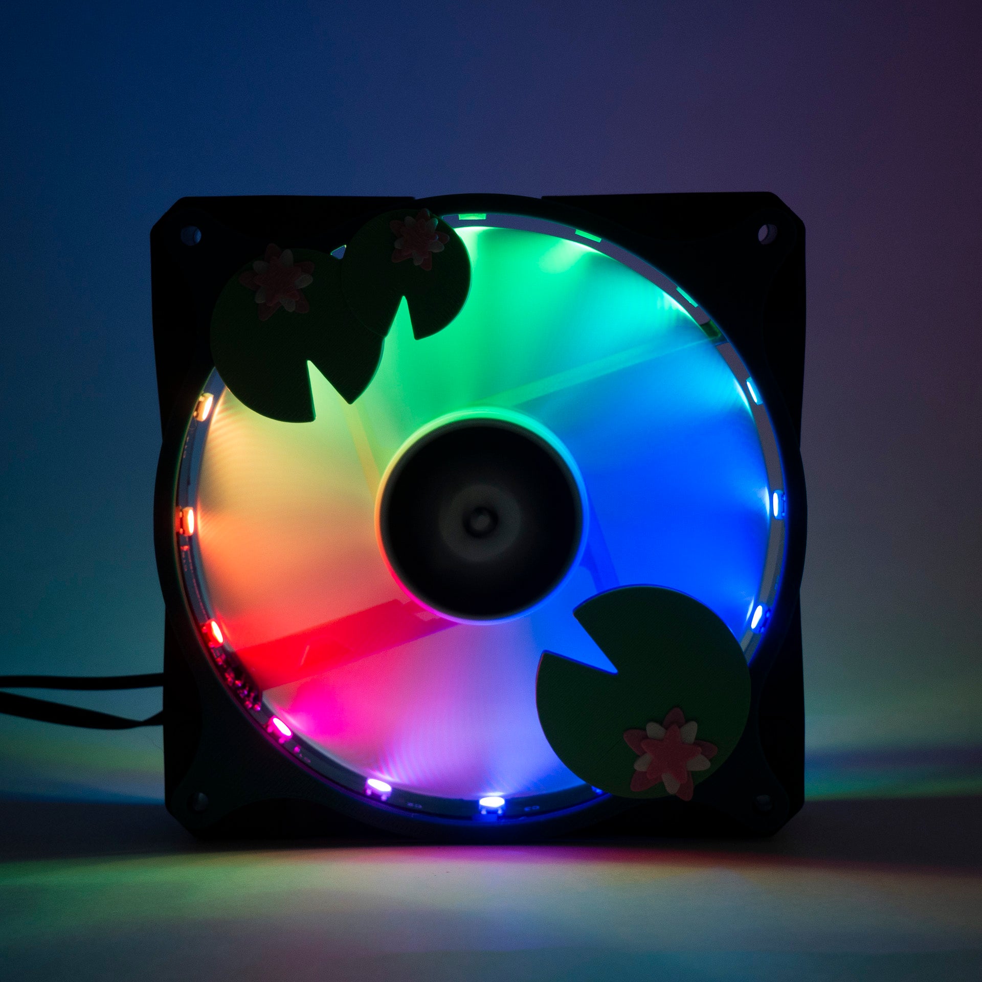Adorable 3D printed PC fan grill with lily pad and lotus flower design. A cute nature-inspired fan cover perfect for cozy, aesthetic gaming setups.