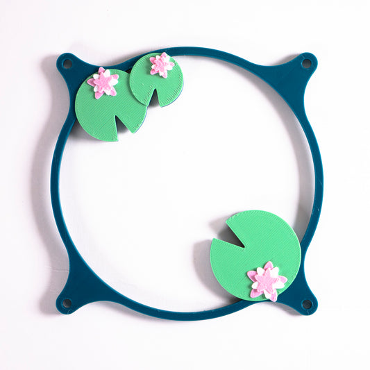 Adorable 3D printed PC fan grill with lily pad and lotus flower design. A cute nature-inspired fan cover perfect for cozy, aesthetic gaming setups.