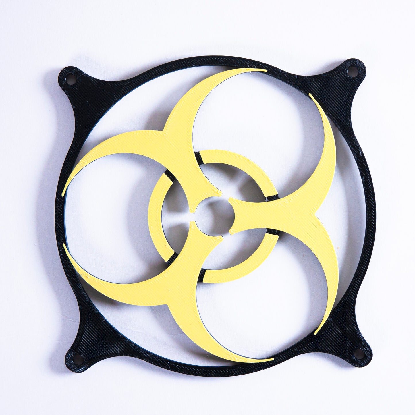 3D printed PC fan grill featuring a bold biohazard symbol. Perfect for custom gaming rigs, PC case mods, and fans of edgy, nerdy, or horror-inspired builds.